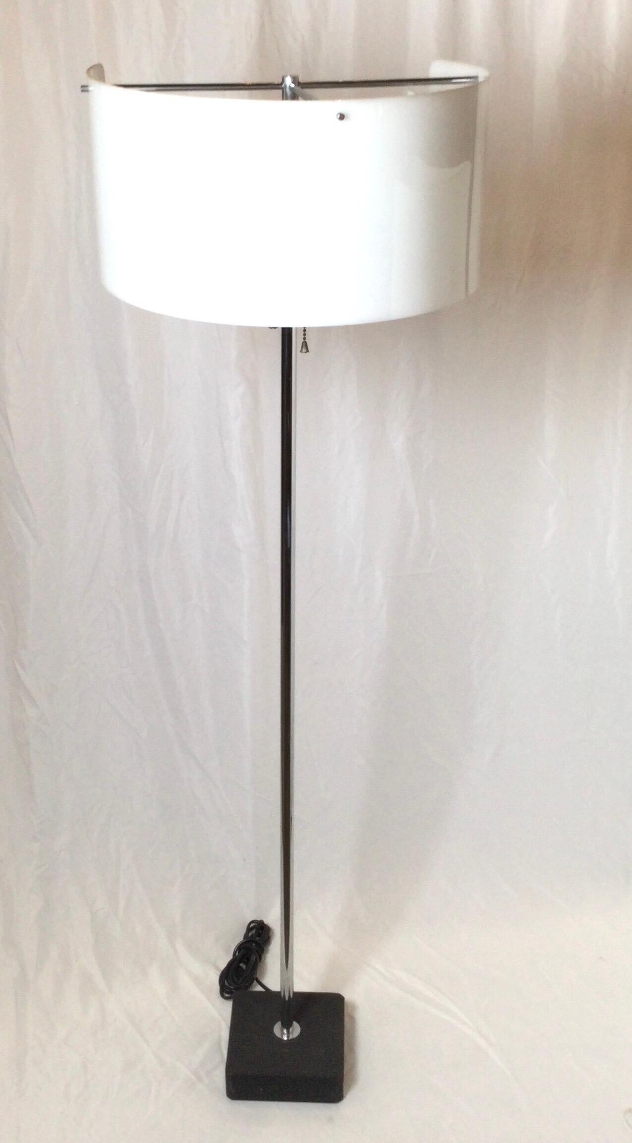 A chrome-plated and enameled aluminum floor lamp with powder-coated steel base, acrylic shade
Decal manufacturer's label to shade ‘AL Milano Arteluce Made in Italy’.