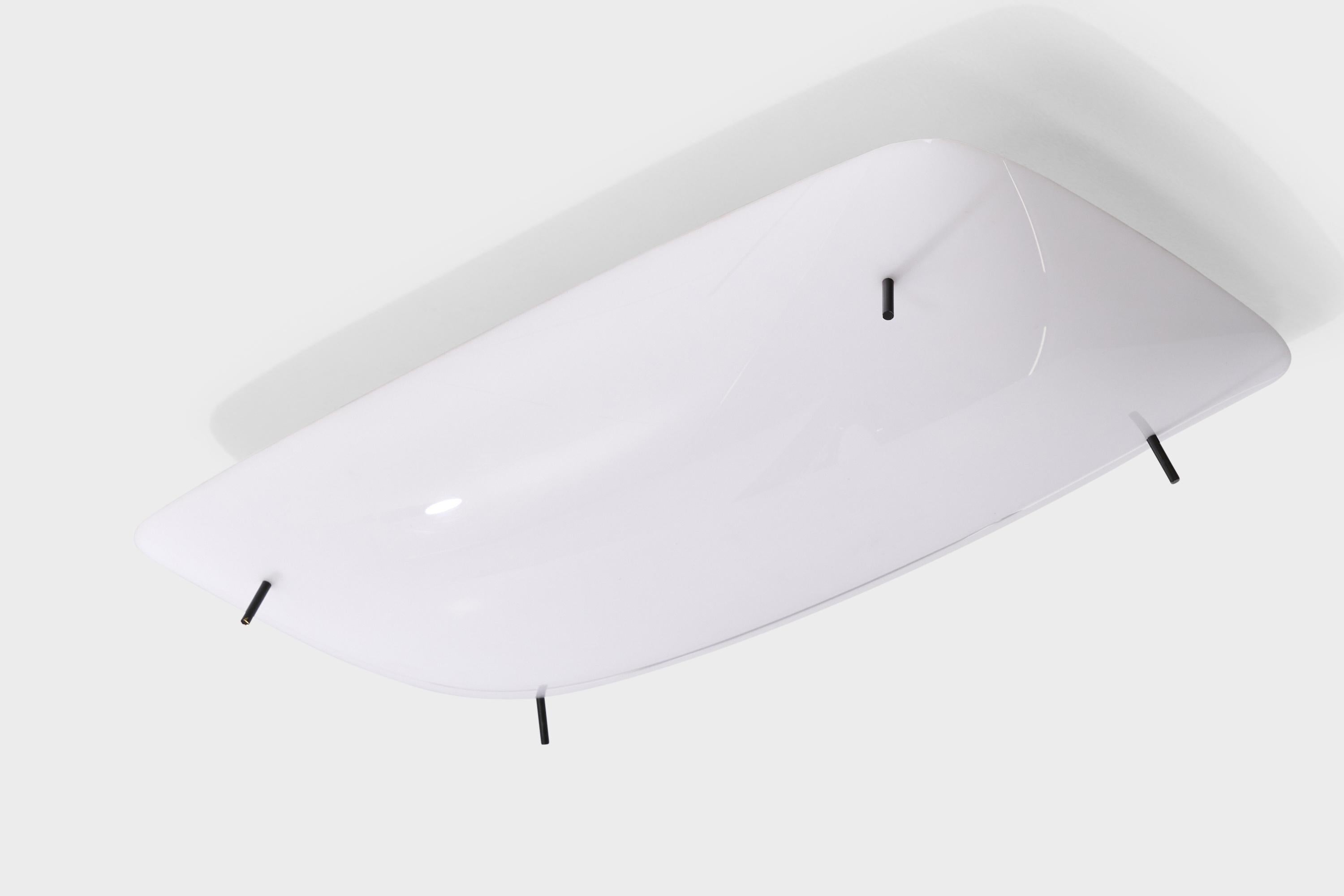 A white acrylic and black-enameled metal flush mount designed by Gino Sarfatti and produced by Arteluce, Italy, 1950s.

Overall Dimensions (inches): 5” H x 25” W x 14” D 

Bulb Specifications: E-26 

Number of Sockets: 4

All lighting will be