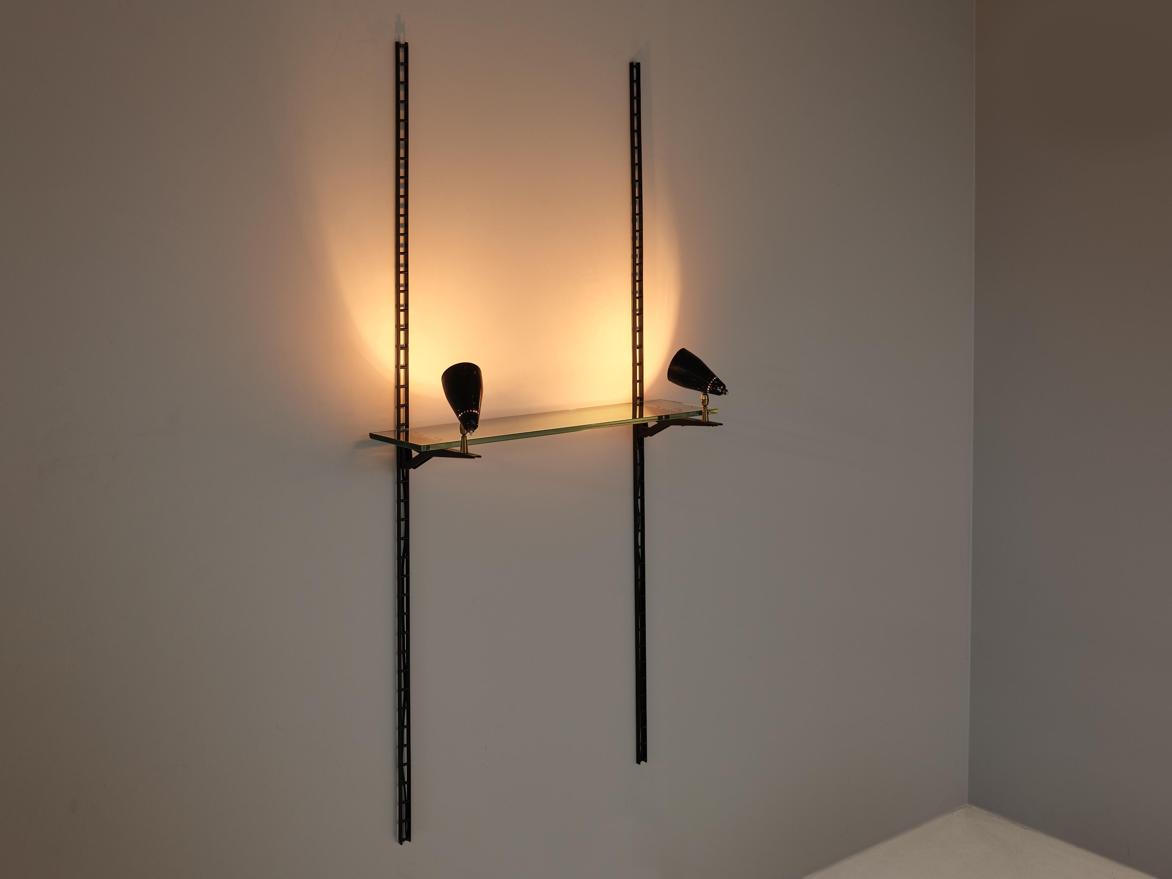 Gino Sarfatti for Arteluce, display console, metal, glass, brass, Italy, 1970s

Two vertical wall mounts in black metal hold a glass shelf. At the end of the fixtures two adjustable lamps are arranged to light up the items you want to showcase. The