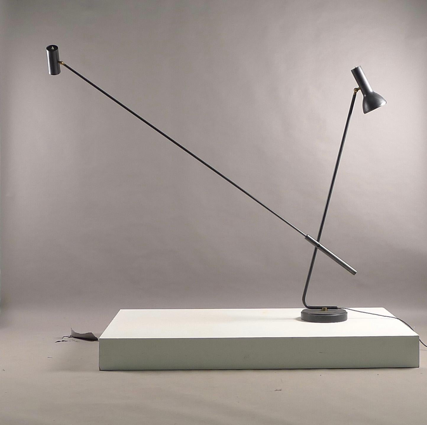 Gino Sarfatti for his own Arteluce Lighting Company, Italy. A 1049/n floor lamp designed circa 1951. Enamelled black aluminium shades are multi directional, supported by two arms, the longer of which also pivots through the axis. All supported by a