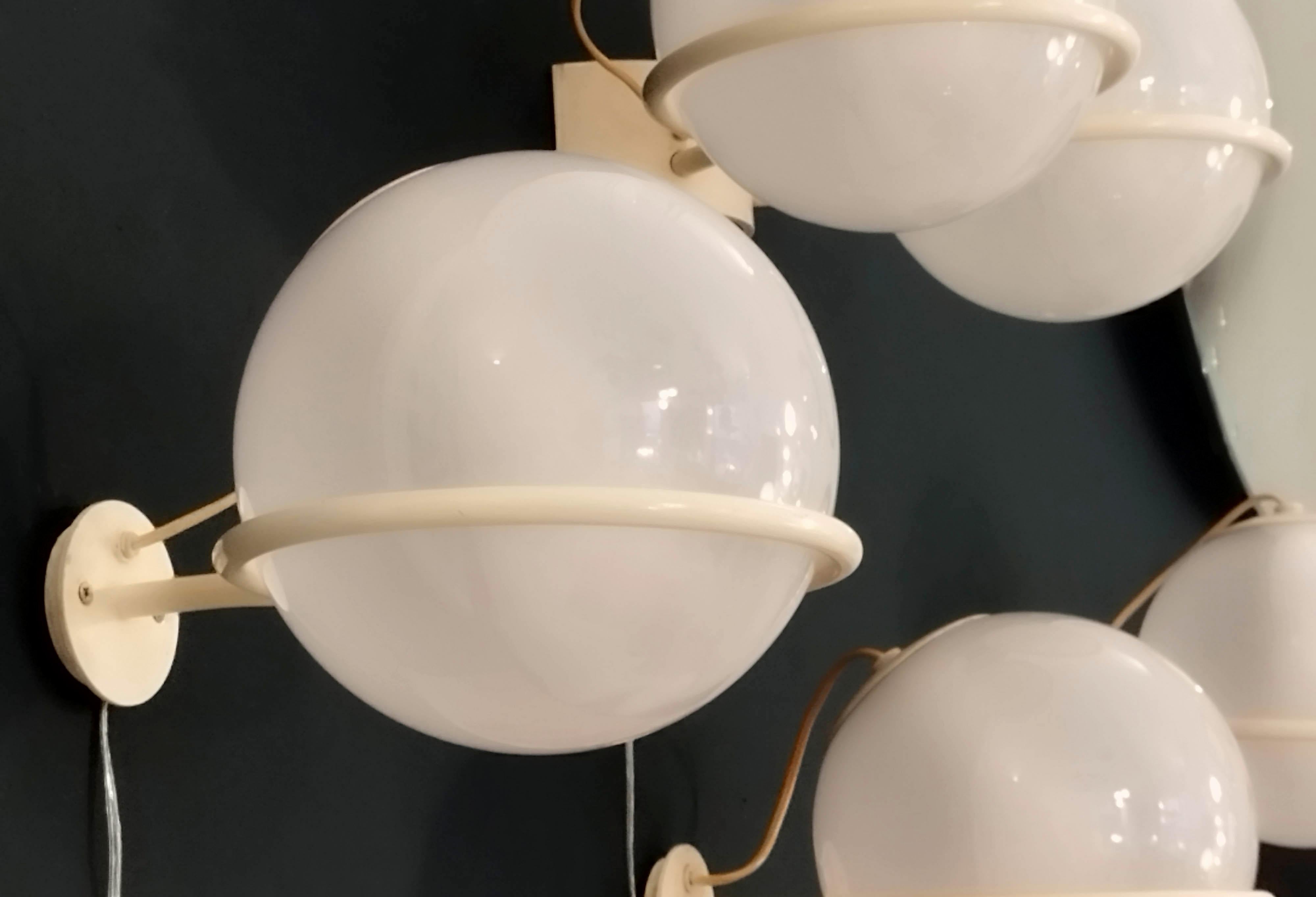 An original wall lamp Mod. 237 designed by Gino Sarfatti. Arteluce 1960 edition. Blown opaline glass on enameled ring that allows the sphere to be positioned downward or upward. Excellent condition. 