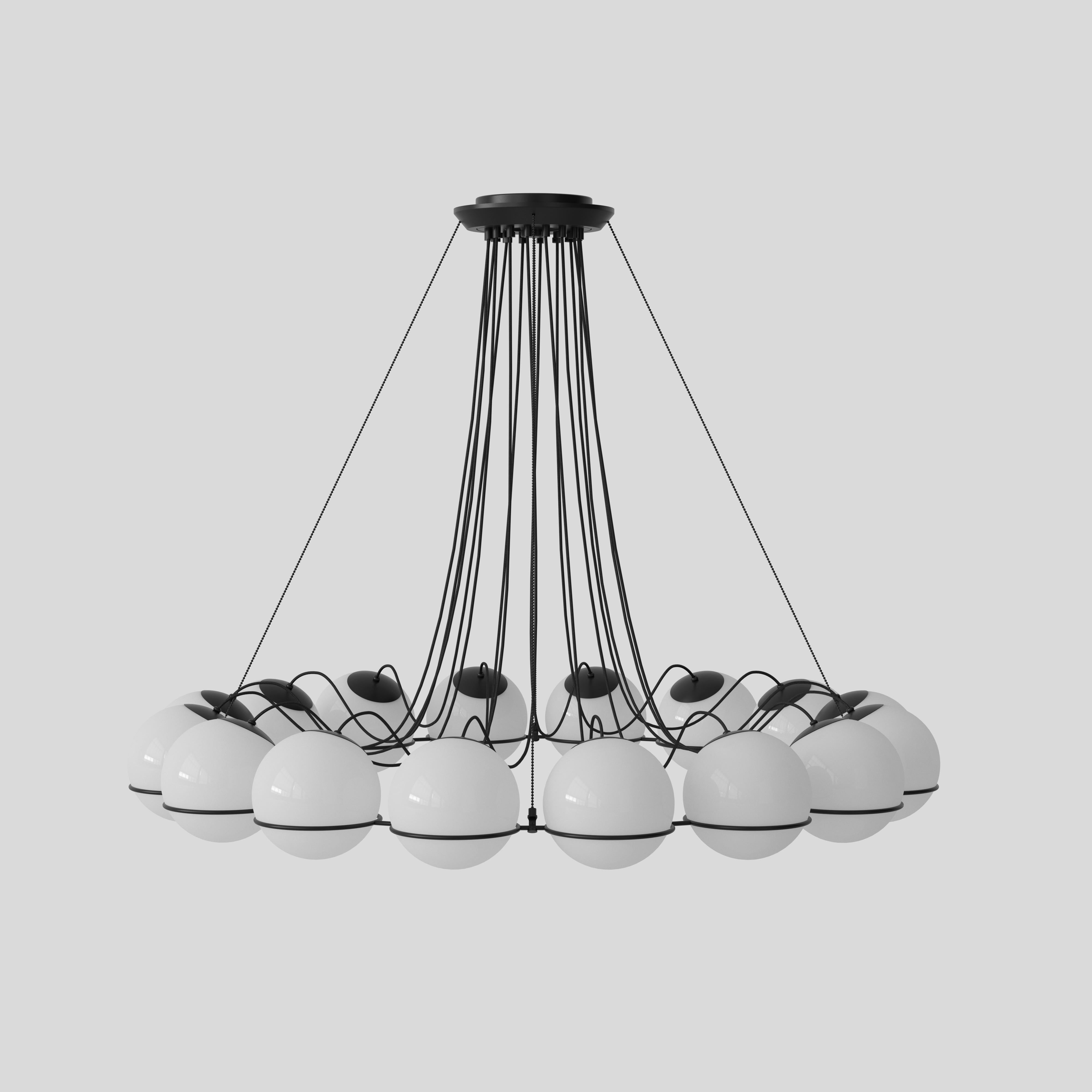 Model 2109
Design by Gino Sarfatti
The Le Sfere Chandelier is composed of a circular array of blown opaline glass spheres. Each sphere is held in place by a large Black or Champagne painted aluminium ring-structure. Each ring has a small cut,