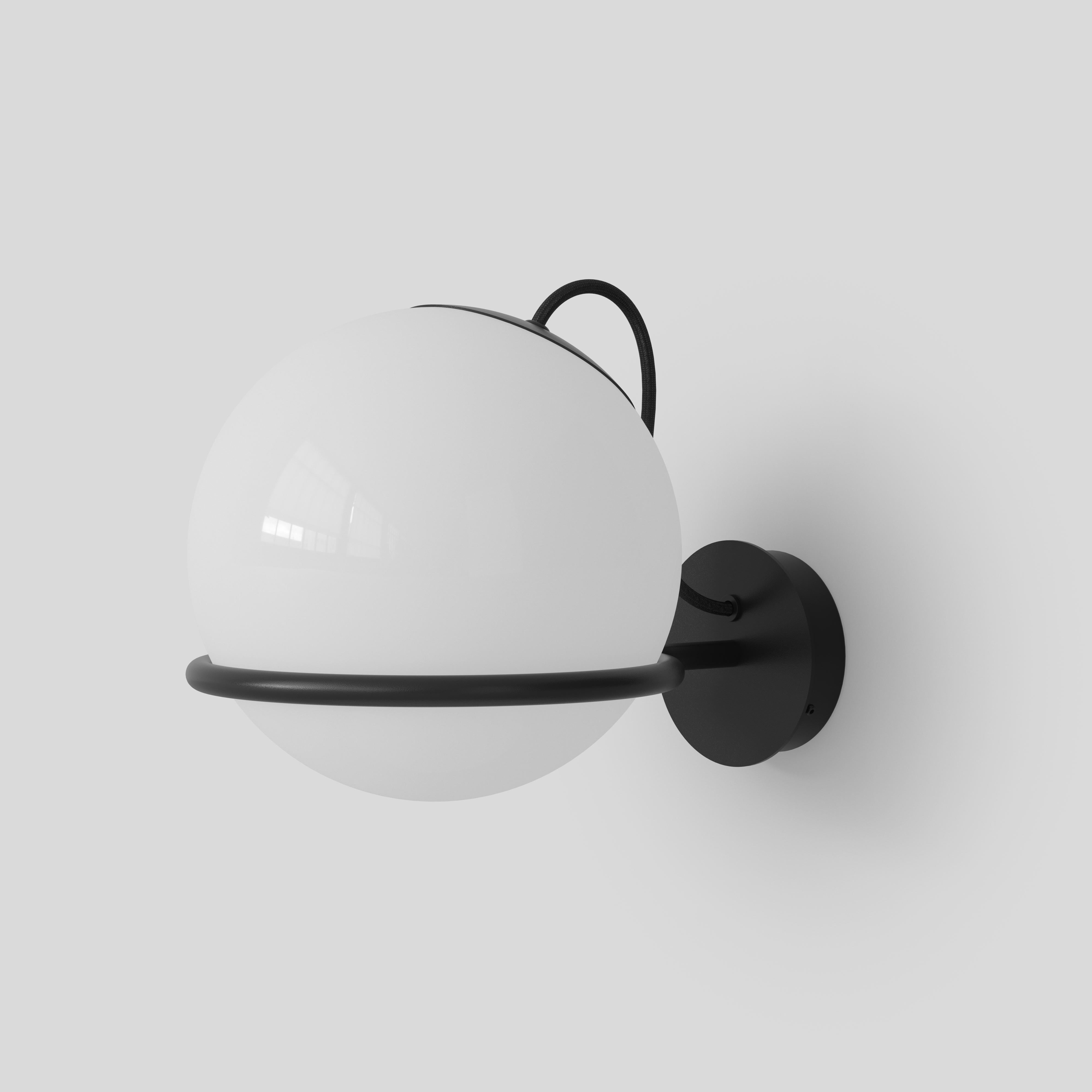 Model 237/1
Design by Gino Sarfatti
The single blown opaline glass sphere is gently held by a Black or Champagne painted aluminium ring. The aluminum ring has a small cut, enabling the sphere to be placed facing downward or upward and thus