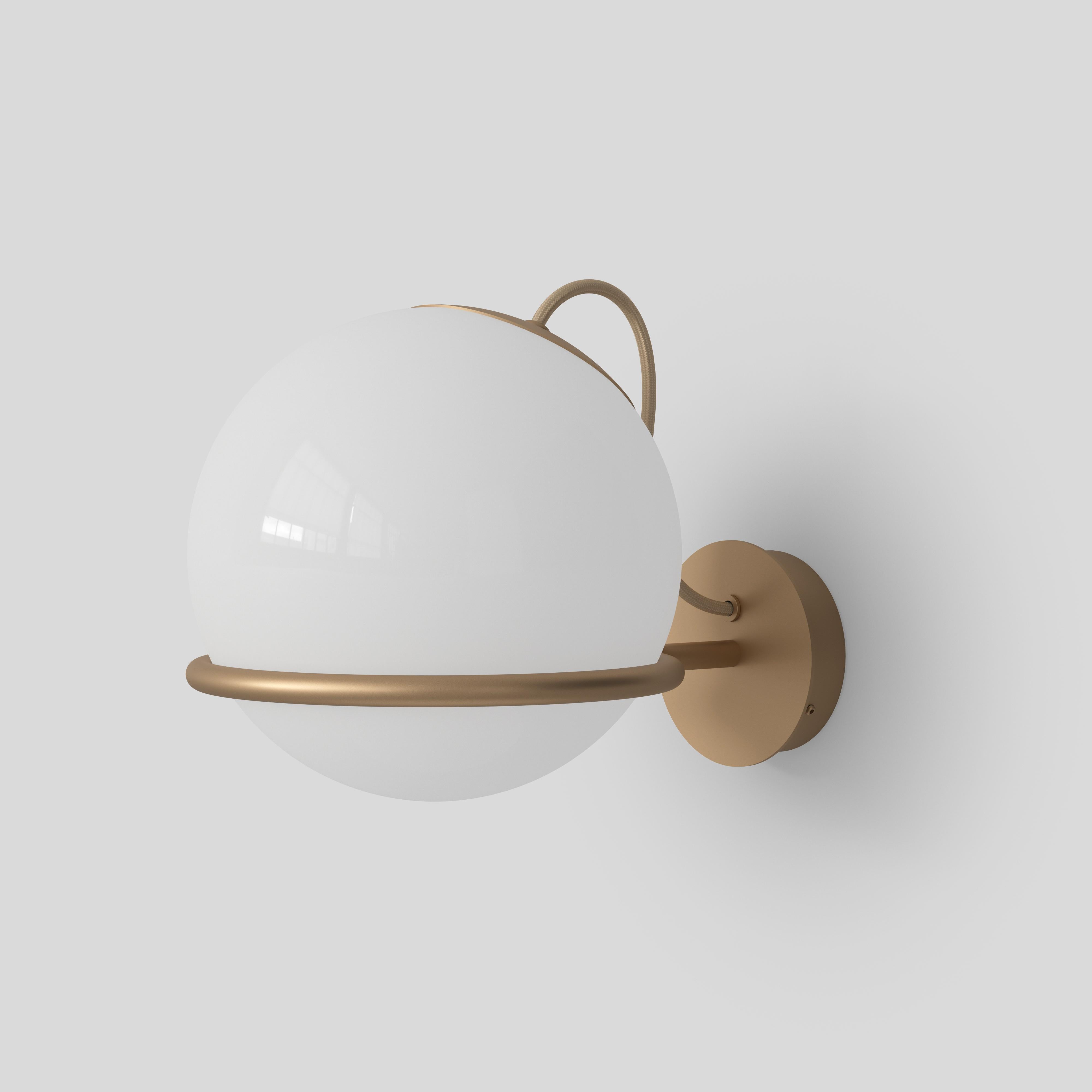 Model 237/1
Design by Gino Sarfatti
The single blown opaline glass sphere is gently held by a black or champagne painted aluminum ring. The aluminum ring has a small cut, enabling the sphere to be placed facing downward or upward and thus providing