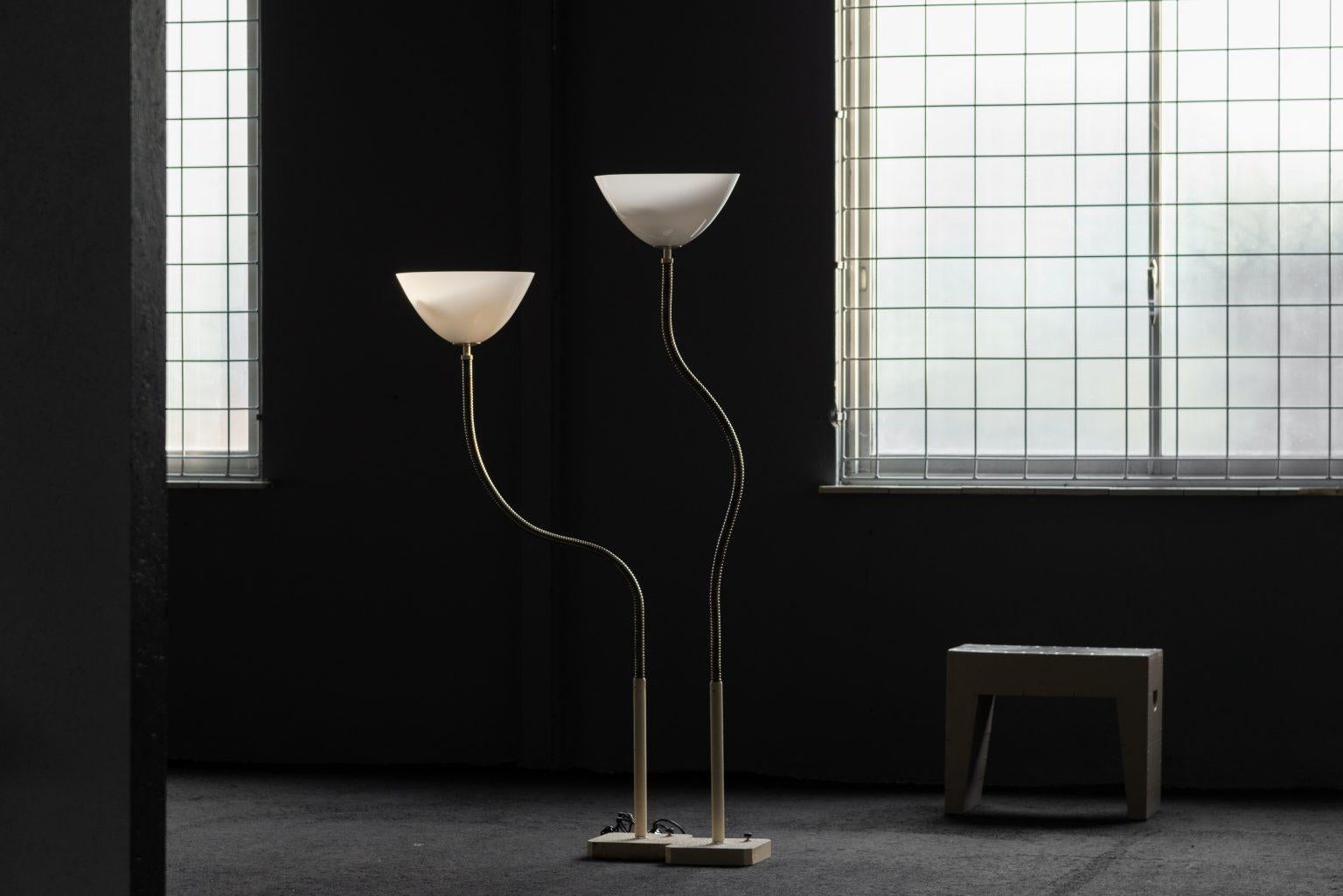 This stunning and rare pair of minimalist floor lamps, Model 1051, was designed by the iconic Gino Sarfatti and manufactured by Arteluce in Italy in 1966. A masterpiece of mid-century modern design, these lamps exude simplicity and sophistication,