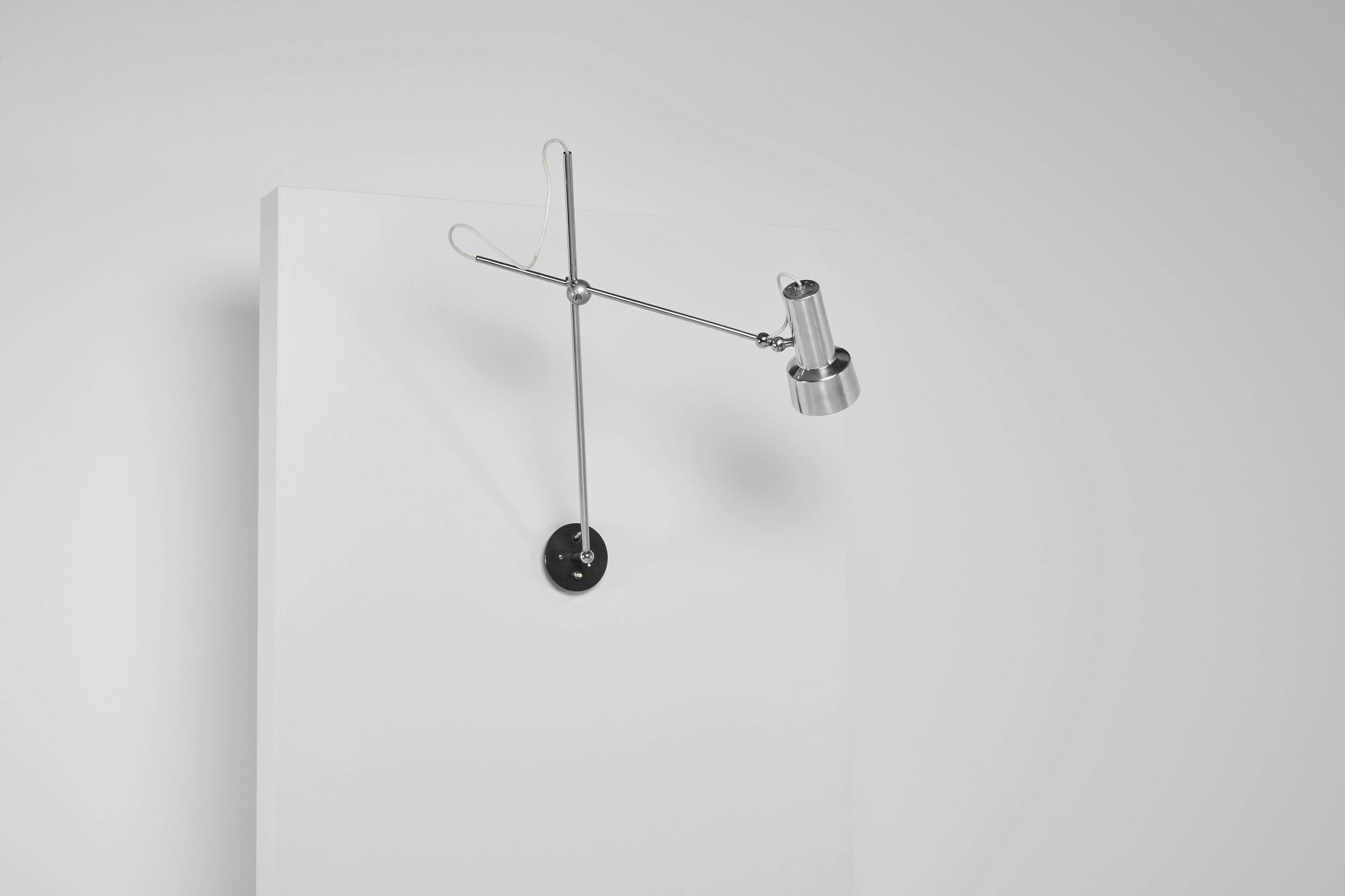 Minimalistic model 213 wall lamp by Gino Sarfatti and manufactured by Arteluce in Italy 1956. This lamp features a direct wall fixture, cleverly designed with chrome-plated brass arms connected by a ball joint, allowing you to easily adjust the