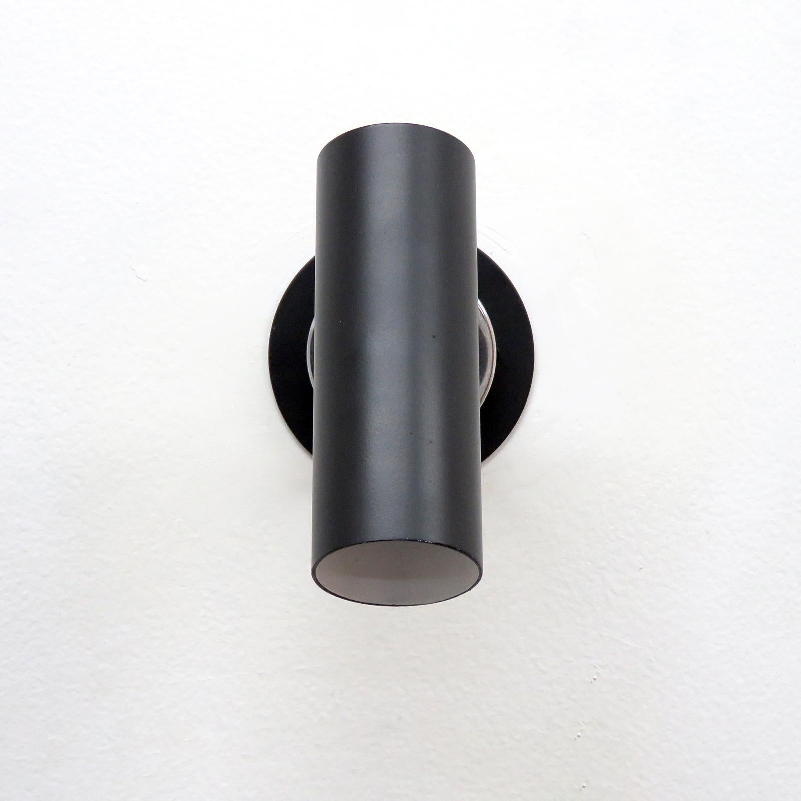 wonderful minimalist wall lights model 31B designed by Gino Sarfatti, manufactured by Arteluce, Italy 1950 with black enameled metal shades on chrome plated double-joint adjustable arms and individual on/off switches on the back plates. Marked with