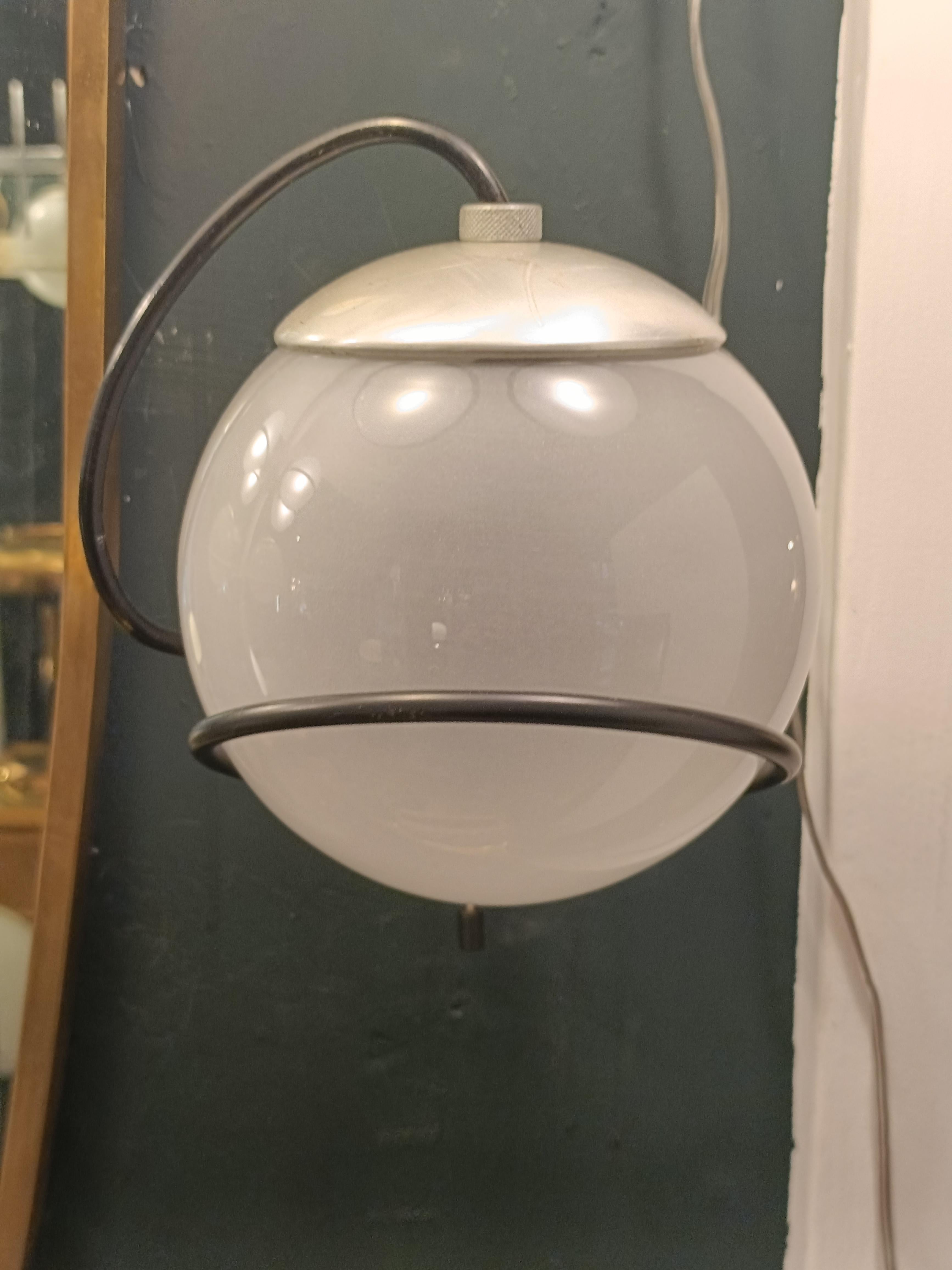 Lampada da parete  modelo 238/1, diseñado por Gino Sarfatti, con estructura de metal lacado en negro y difusor de esfera de vidrio opalino soplado. Gino Sarfatti (1912-1985) es considerado el 