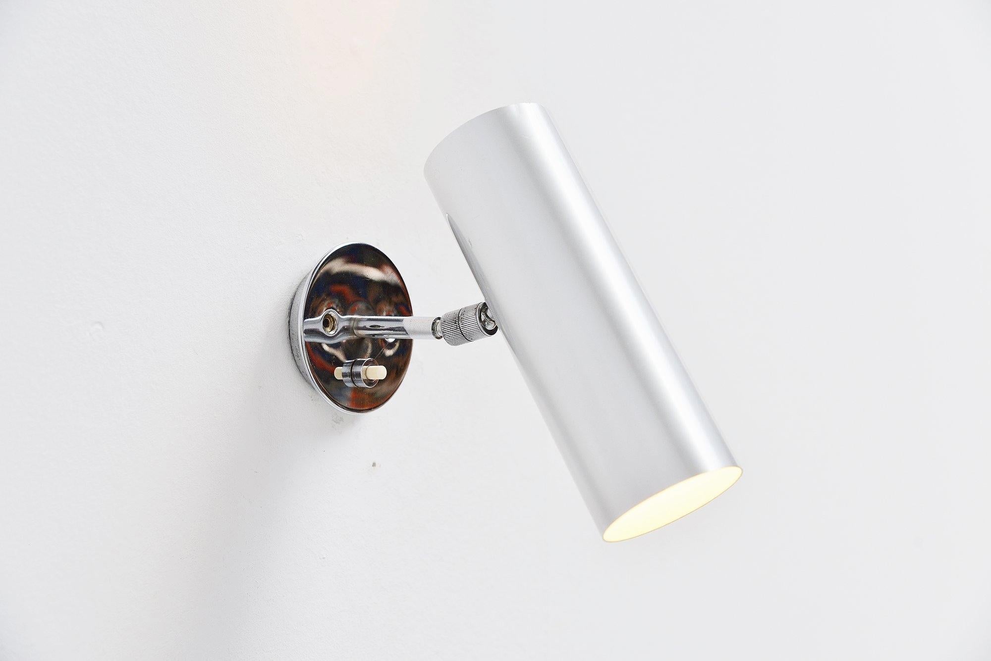 Minimalist wall lamp model 31B designed by Gino Sarfatti, manufactured by Arteluce, Italy 1950. The light has an aluminium shade, with chrome plated adjustable wall arm. The lamp is unmarked but written with the quality of Arteluce all over. This