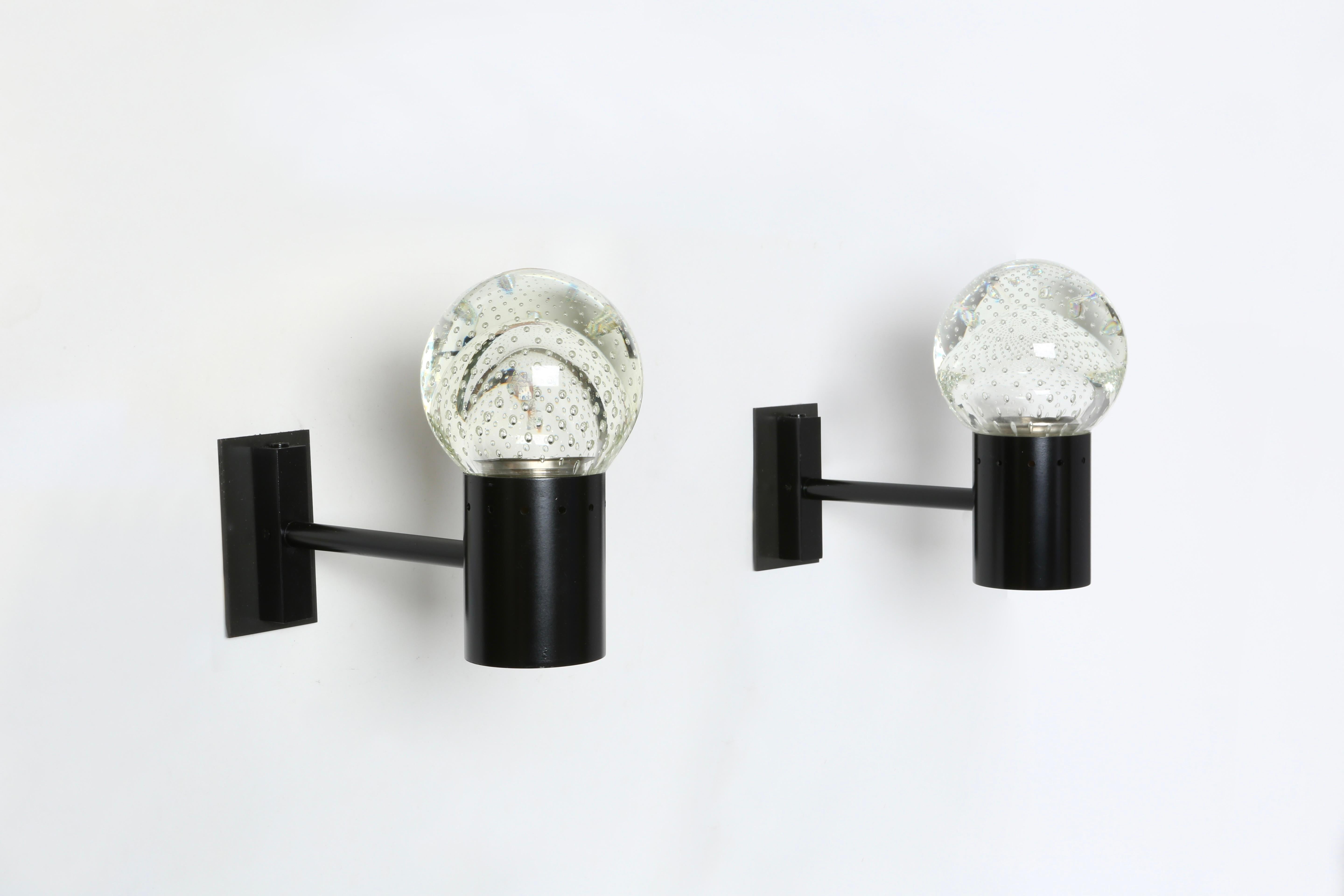 Gino Sarfatti sconces for Seguso, a pair
Designed and manufactured in Italy in 1950s
Seguso bullicante glass and enameled metal frames.
Rewired for US with custom back plates in patinated brass.
Refinished, re-enameled.

We take pride in bringing