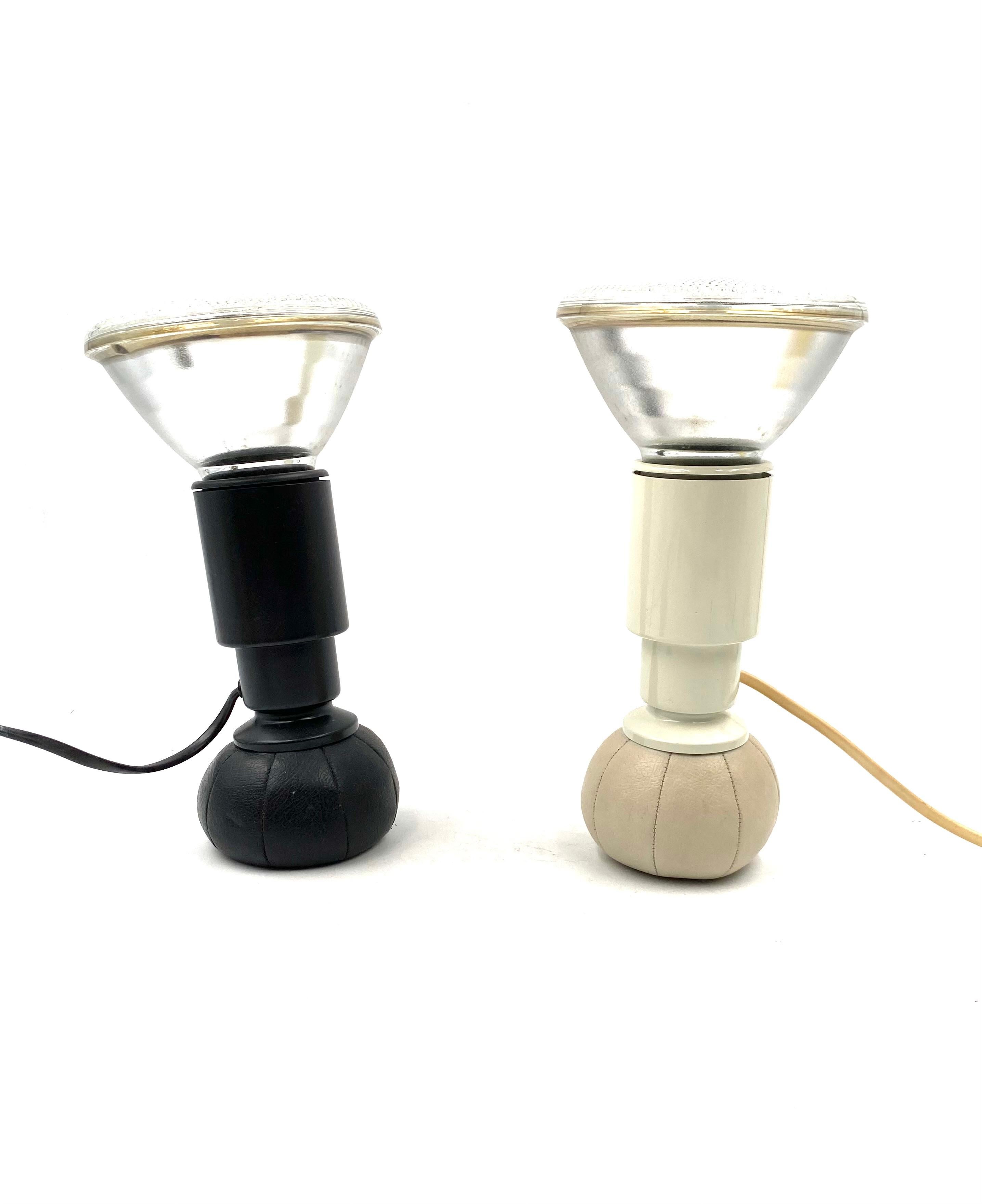 Set of 2 black & white table lamps mod. 600/C designed by master Gino Sarfatti, manufactured by his own Arteluce.

Designed in 1966, produced 1960 - 1969

Lacquered aluminium. The leather base is filled with small lead balls which allow the lamp