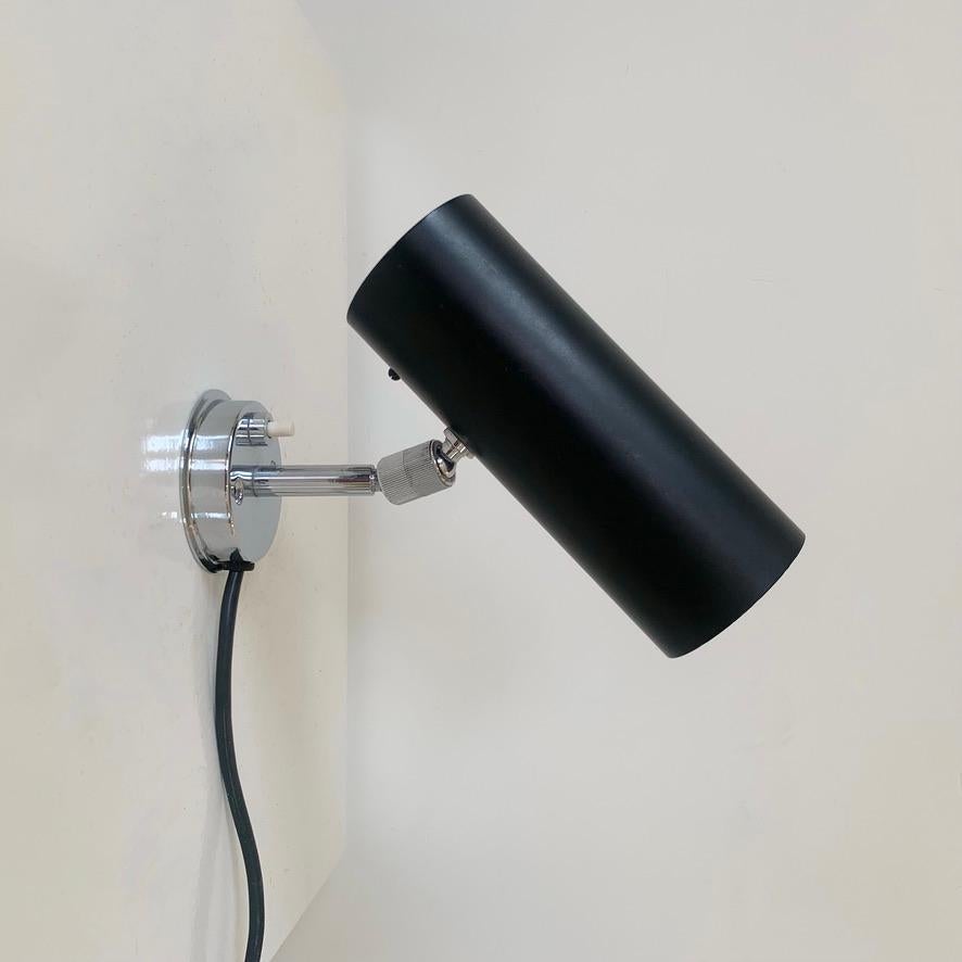 Gino Sarfatti  wall light, 31 B model for Arteluce, circa 1950, Italy.
Black and white laquered metal, rotating chromed joints and  switch on the base. 
Original  Arteluce label.
Good condition.
Dimensions: 17 cm H, 17 cm D, 7 cm W.
All purchases
