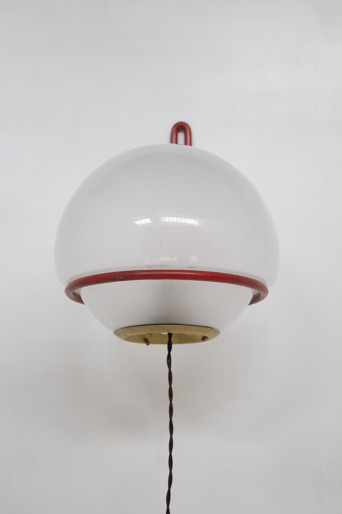 Beautiful pair of red painted metal wall sconces designed by Gino Sarfatti for the fine Italian manufacture.
The structure of the lamp is basket-shaped, that is, it has a longer band, which will be hooked to the wall, while the round part