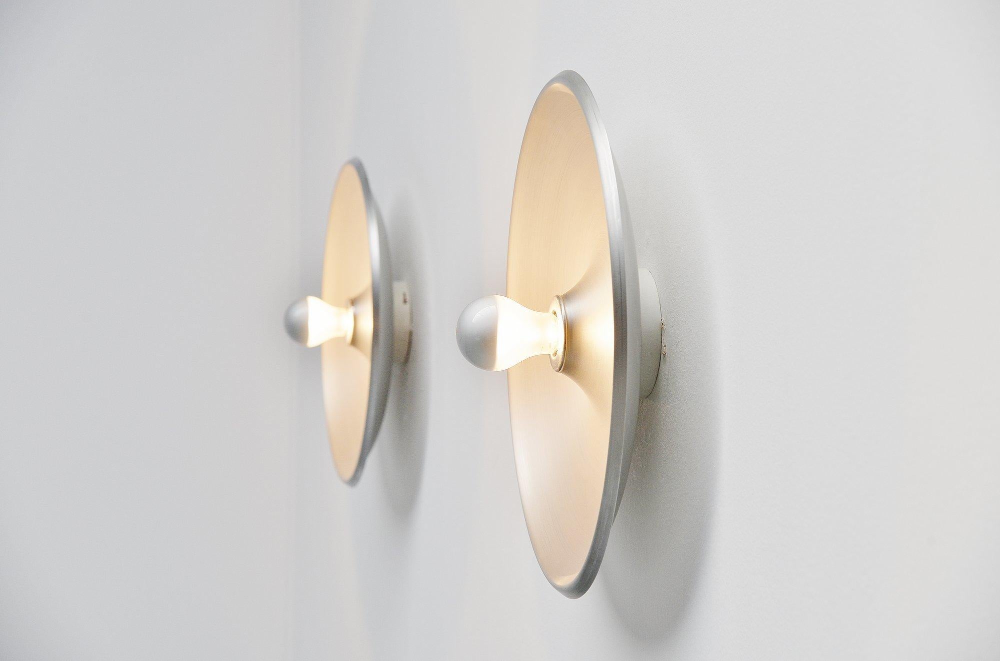 Fantastic pair of large wall/ceiling lamps model 262 designed by Gino Sarfatti, Italy 1971. This pair of wall lamps has an aluminum round shade which reflects the light very nicely when lit. The lamps are marked with the Arteluce sticker on the