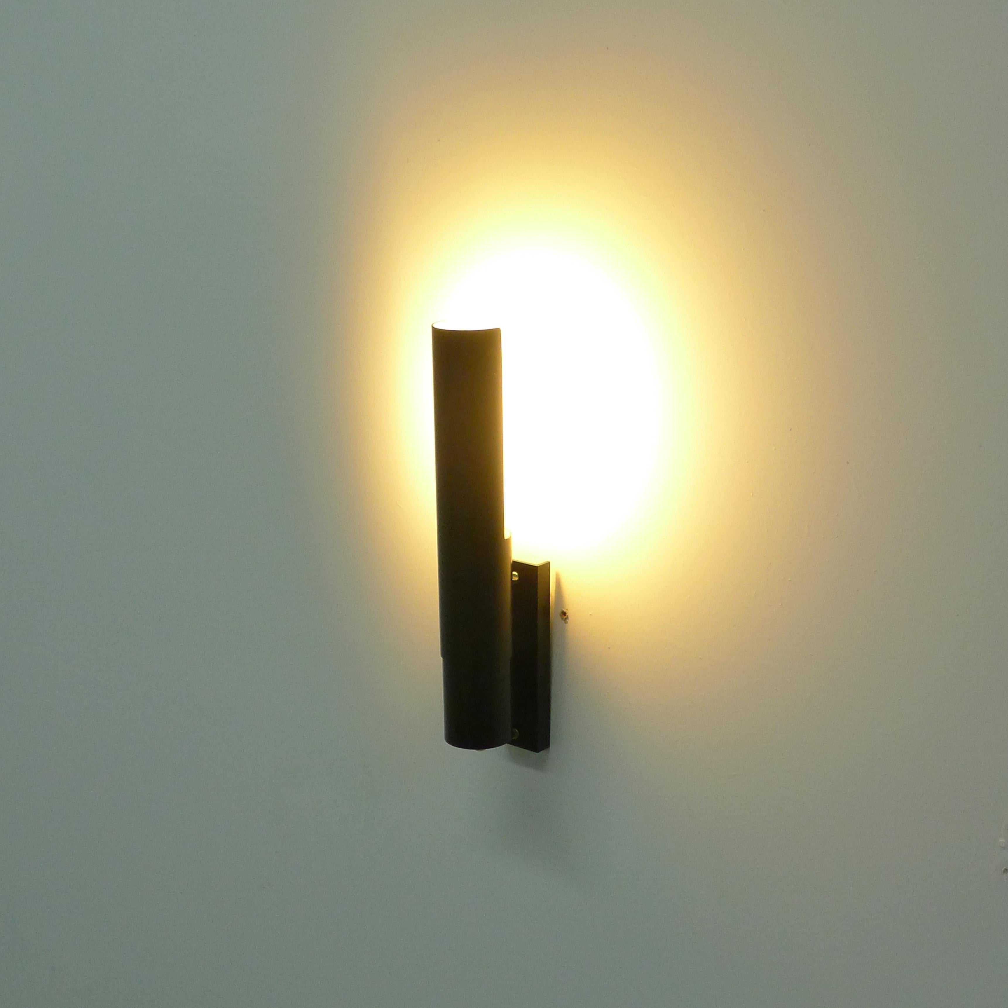 Gino Sarfatti, Wall Sconce, model 211, designed 1955 and manufactured by Arteluce in the 1950s.

In black lacquered aluminium with reflector that rotates on its own guard axis, so that light be can directed where required.

Arteluce label to the