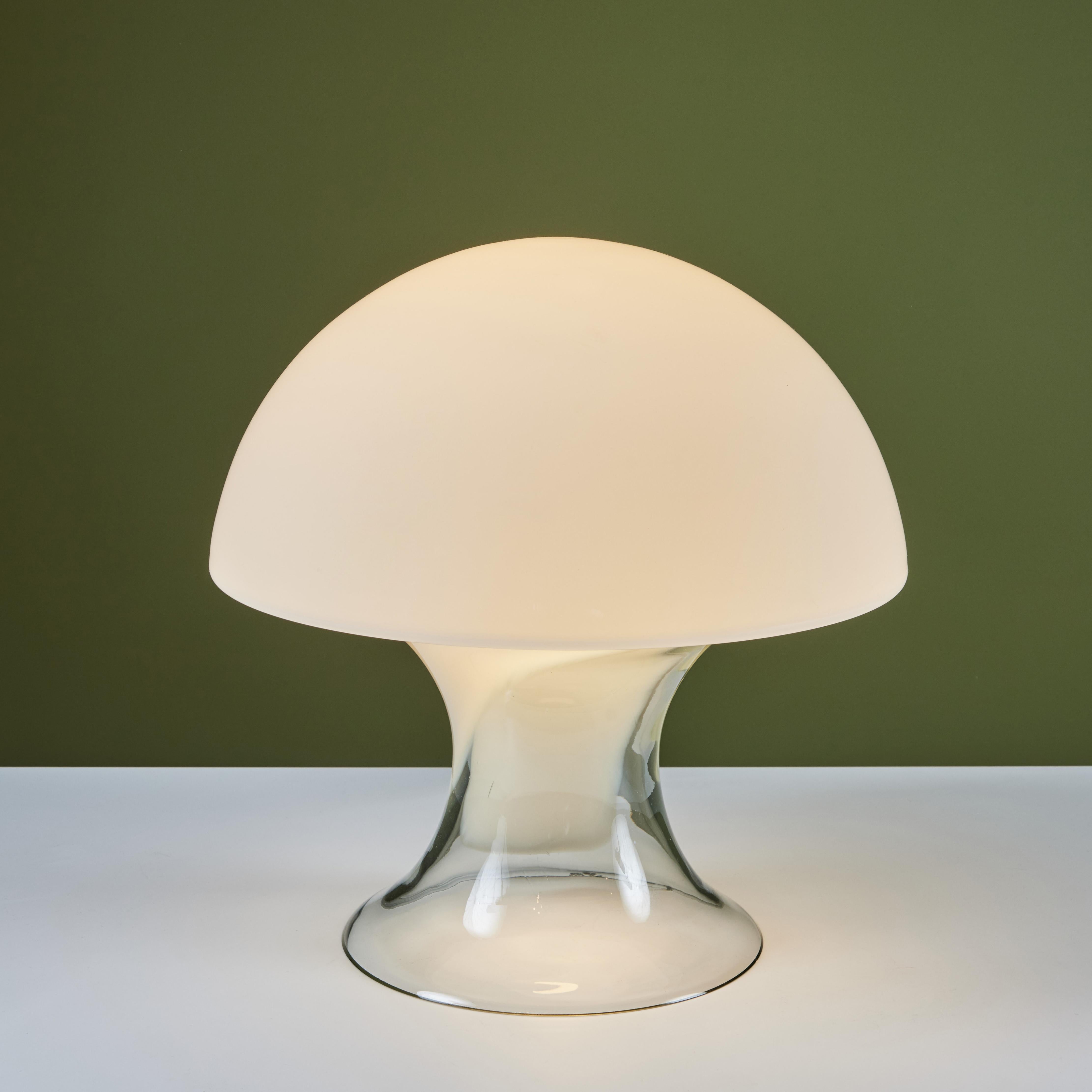 Table lamp by Gino Vistosi, c.1970s, Italy, is sure to light up any room in your home. The lamp features a hand blown murano glass with a frosted mushroom top which cascades into the base ending in a clear glass. The lamp has been newly rewired.
Two