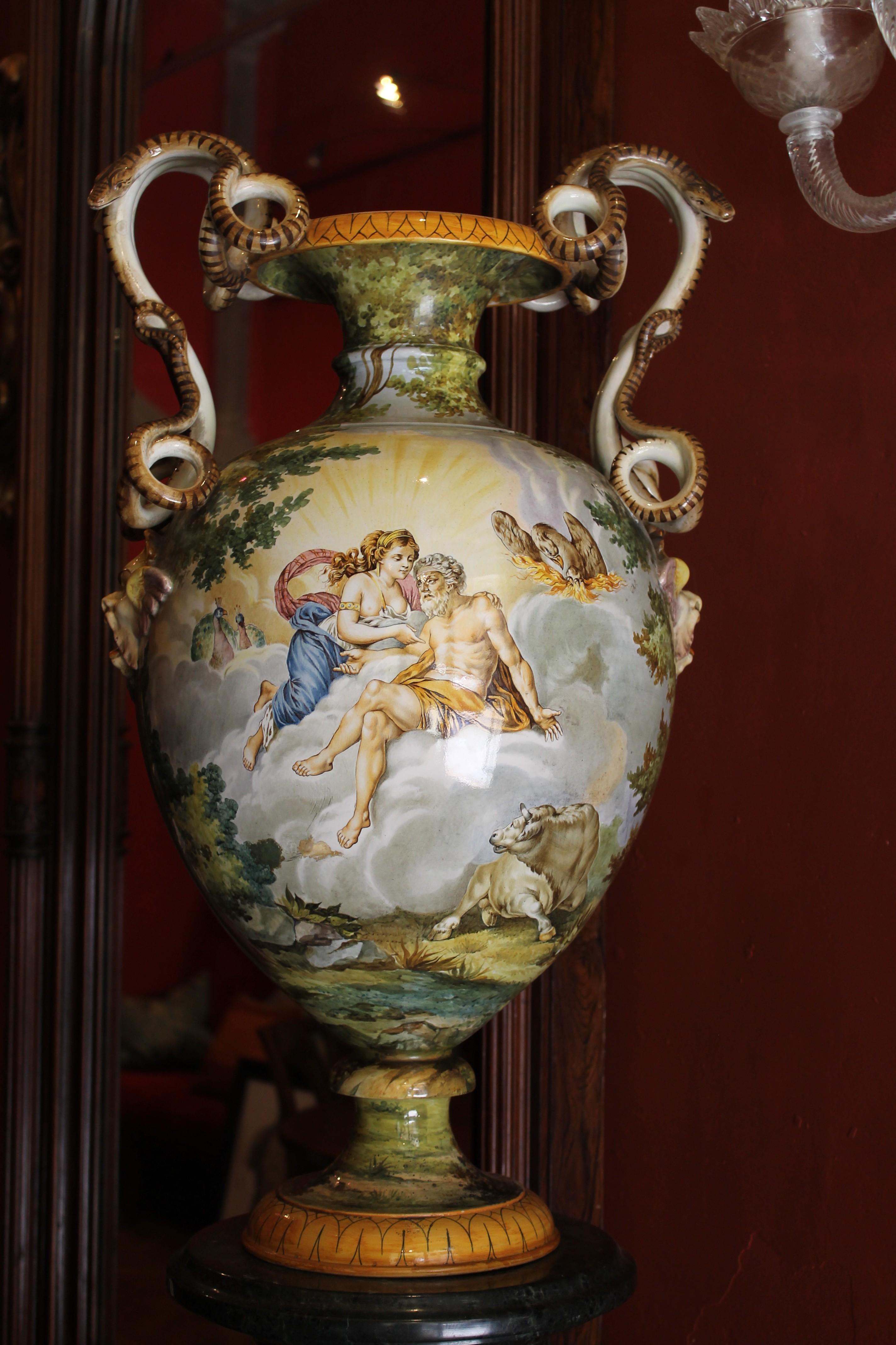 This Italian late 19th century Renaissance style hand painted faience allegorical snake handled vase is the artwork signed by Ginori, one of the most important Italian porcelain and majolica manufacture based in Florence. 
Exquisite polychromed