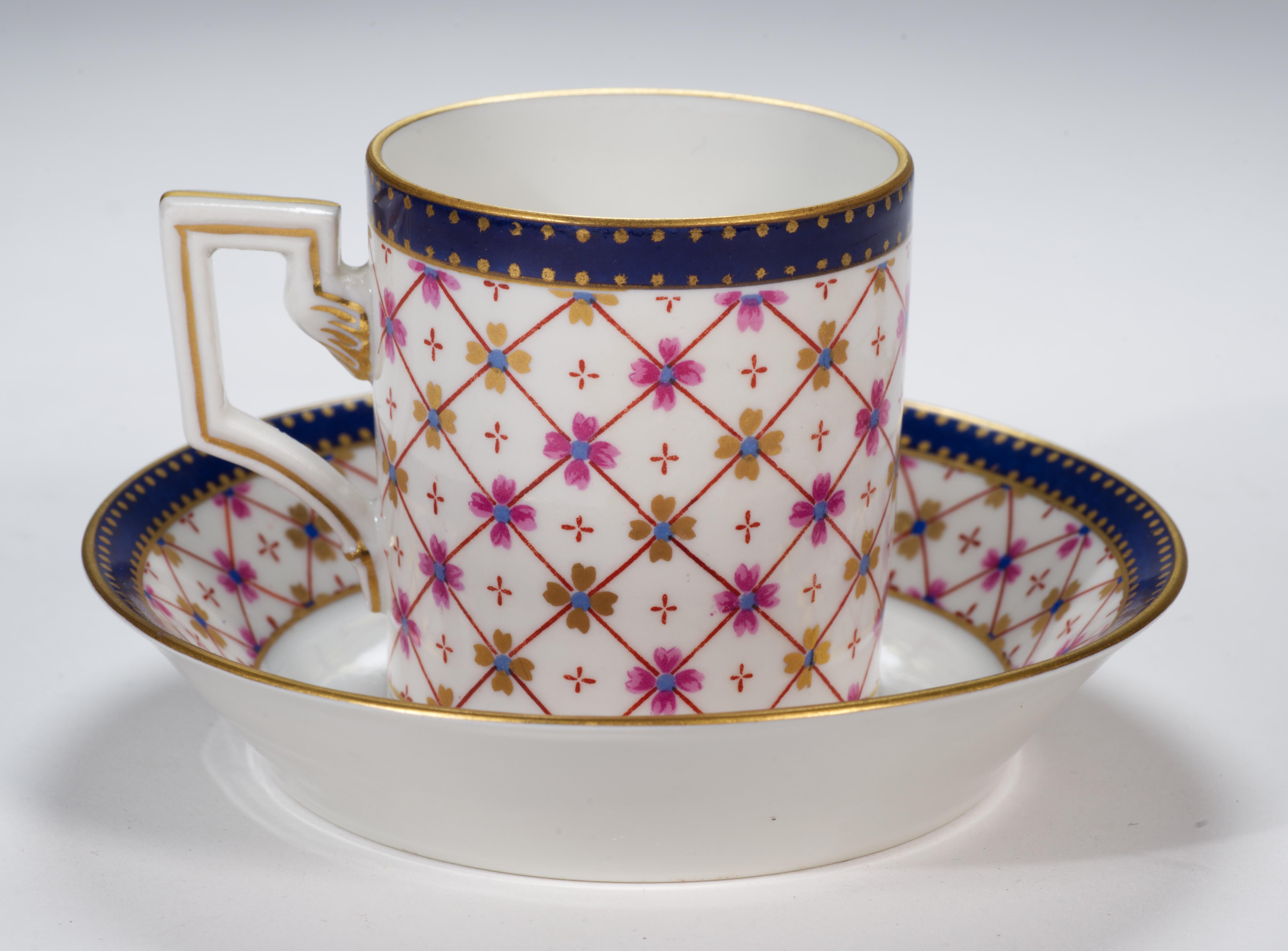 Raro juego de taza y platillo para café expreso o demitas Richard Ginori, fabricado en fina porcelana semitranslúcida en Italia. Está decorada con motivos geométricos abstractos con cuadrícula de rombos acentuada con flores rosas y doradas; el