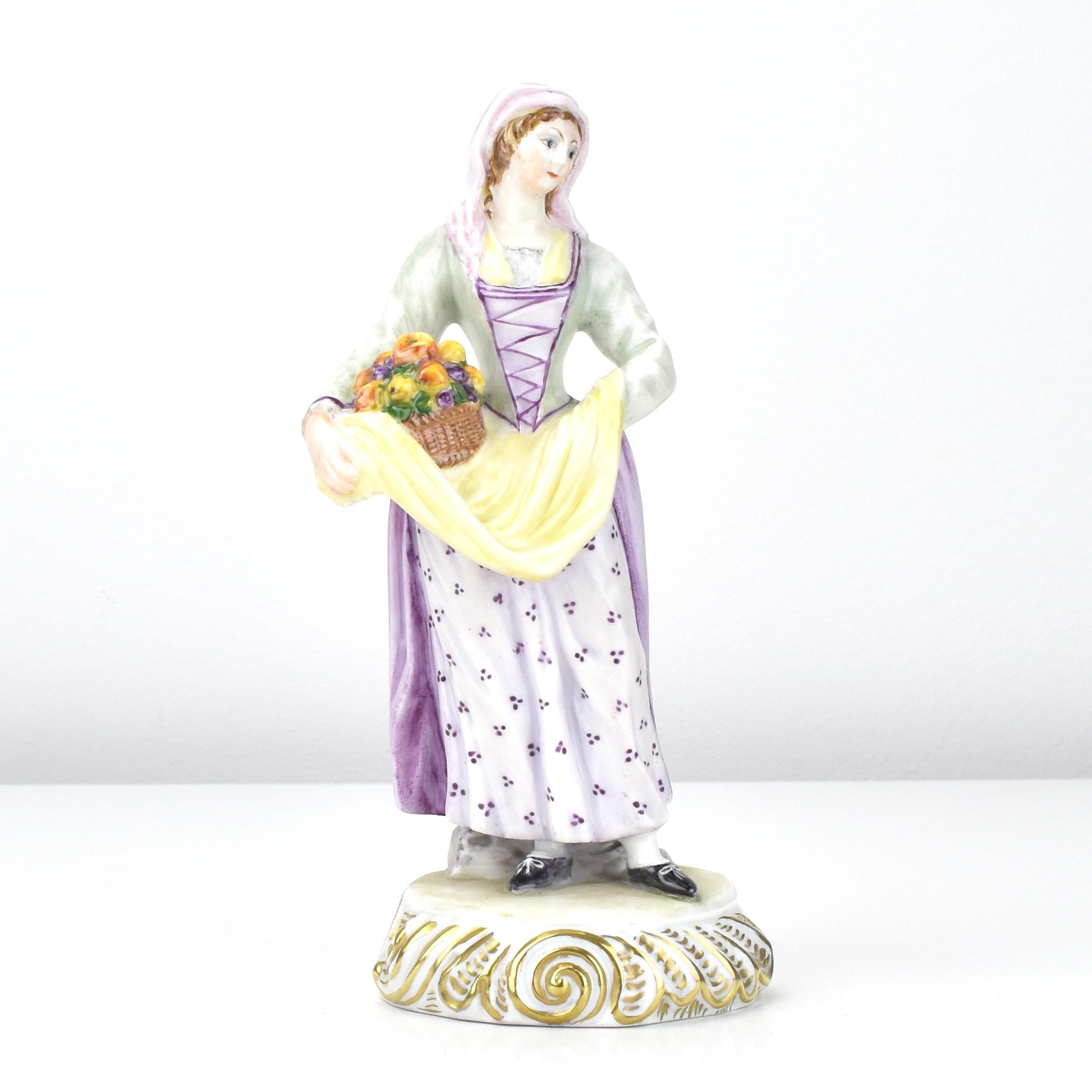 A beautiful set of three vintage porcelain figurines by Ginori, featuring two women carrying baskets of flowers and a man leaning against a tree stump. Each figure is crafted with attention to detail, from the traditional clothing to the expressive