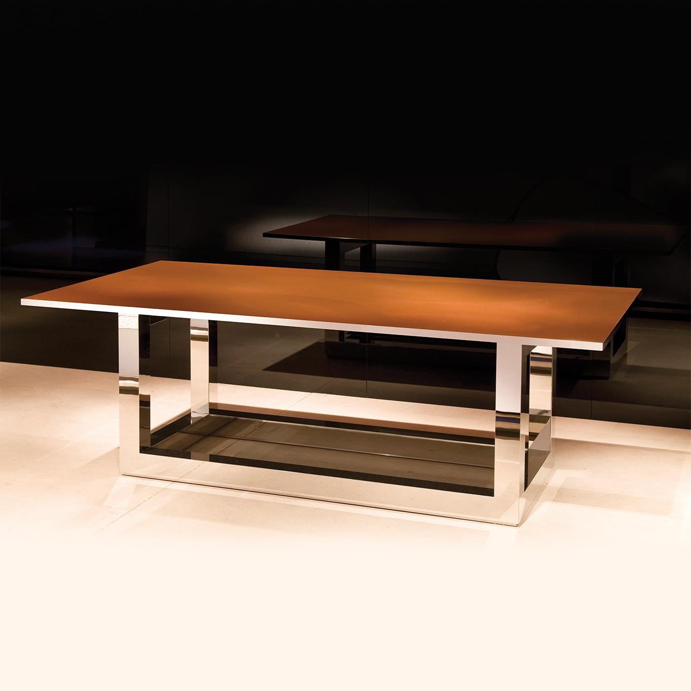 Stunning in its simplicity, the Ginza table features a sturdy structure in polished stainless steel, complimented with a spectacular natural copper tabletop, with the edges around the rectangular top also in polished stainless steel to beautifully