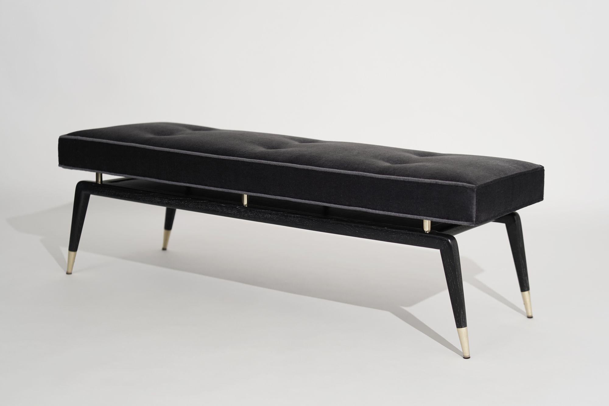 Elevate your space with airy innovation. The Gio Bench is inspired by Gio Ponti – a visionary leader in Italian design. This floating cushion perches on top of solid brass pillars and hangs over a narrow frame. Charcoal grey mohair compliments the