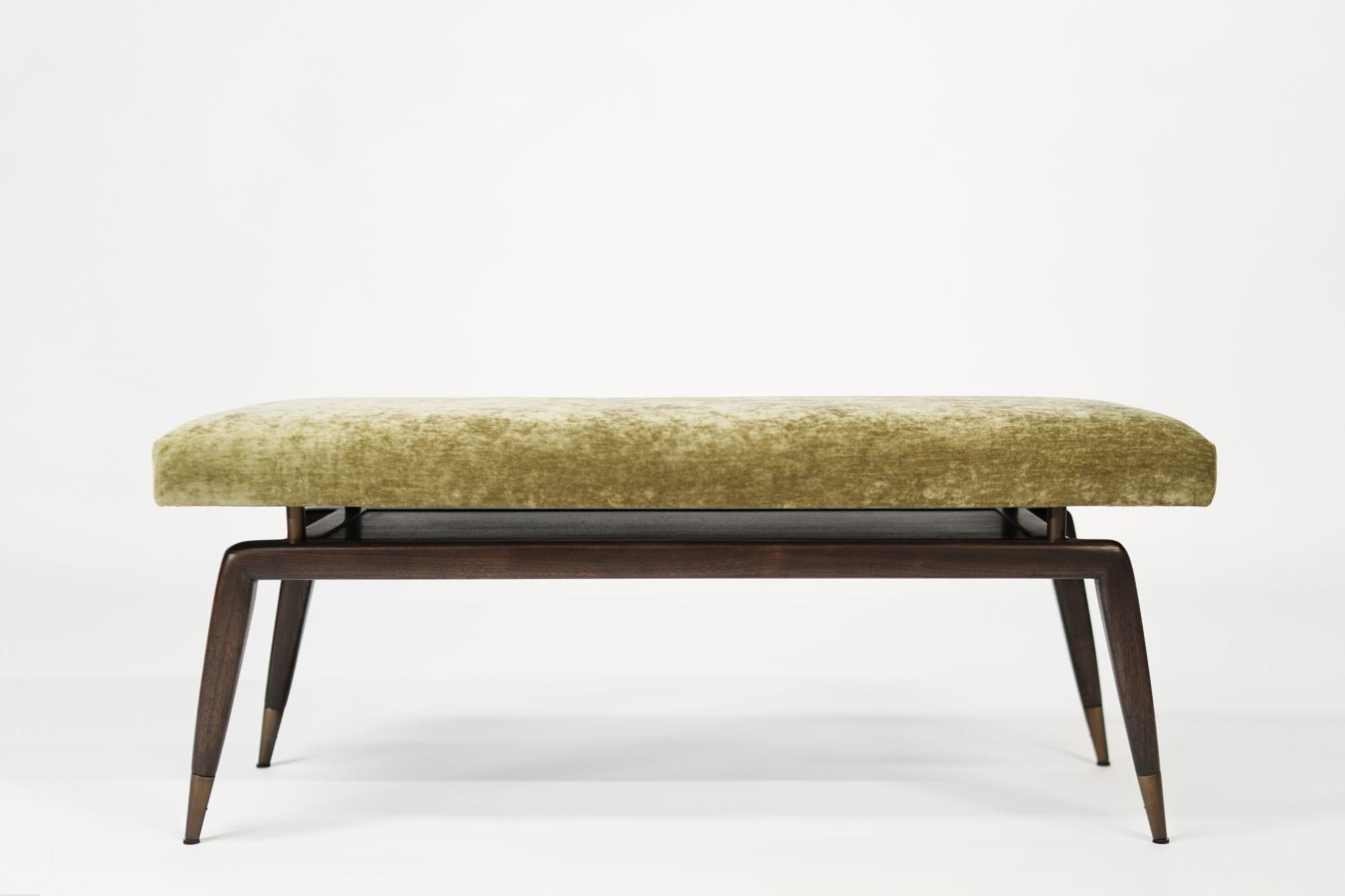 The Gio Bench by Stamford Modern: a perfect blend of Gio Ponti's timeless design and modern functionality. This elegant bench features signature angled legs with metal sabots for added stability and longevity. The upholstered cushion, elevated by