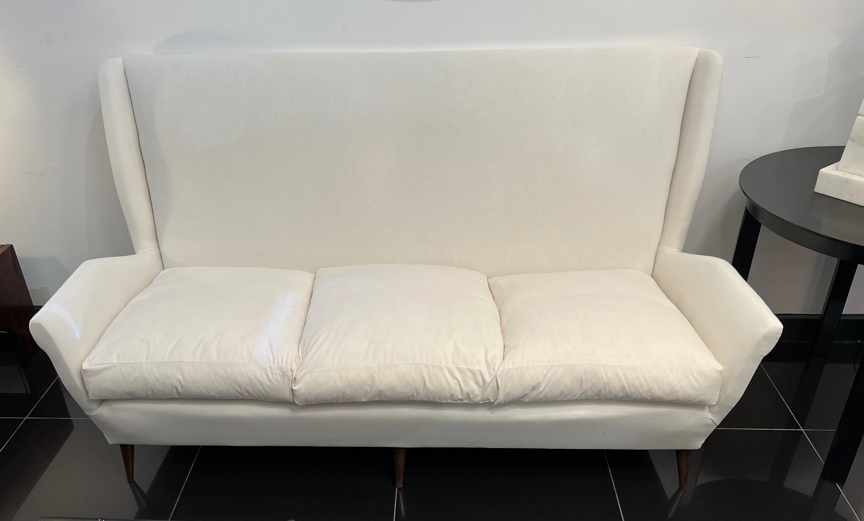 High back three seater sofa with refined lines and outstanding comfort produced by ISA bergamo for Gio Ponti model 512 . 
The sofa has been completely restored and currently covered in calico fabric ready for final upholstery. 
Lit. Gio Ponti the