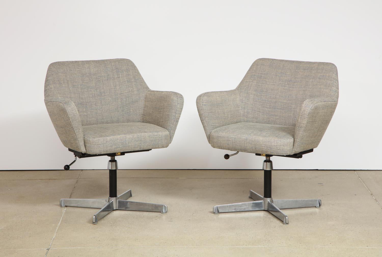 Upholstered form seat and back over chrome-plated and enameled steel swivel base. Manufacturers label to underside.