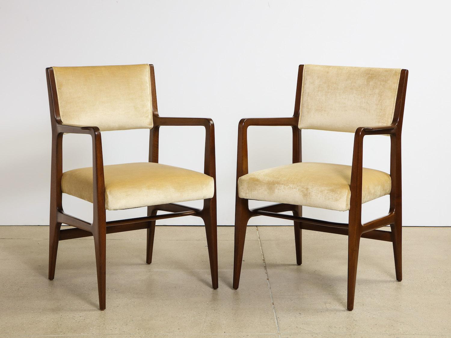 Rare pair of armchairs by Gio Ponti for M. Singer & Sons. Mahogany frames with recently upholstered seat & back. Iconic Ponti forms in excellent condition. 2nd matching pair available.