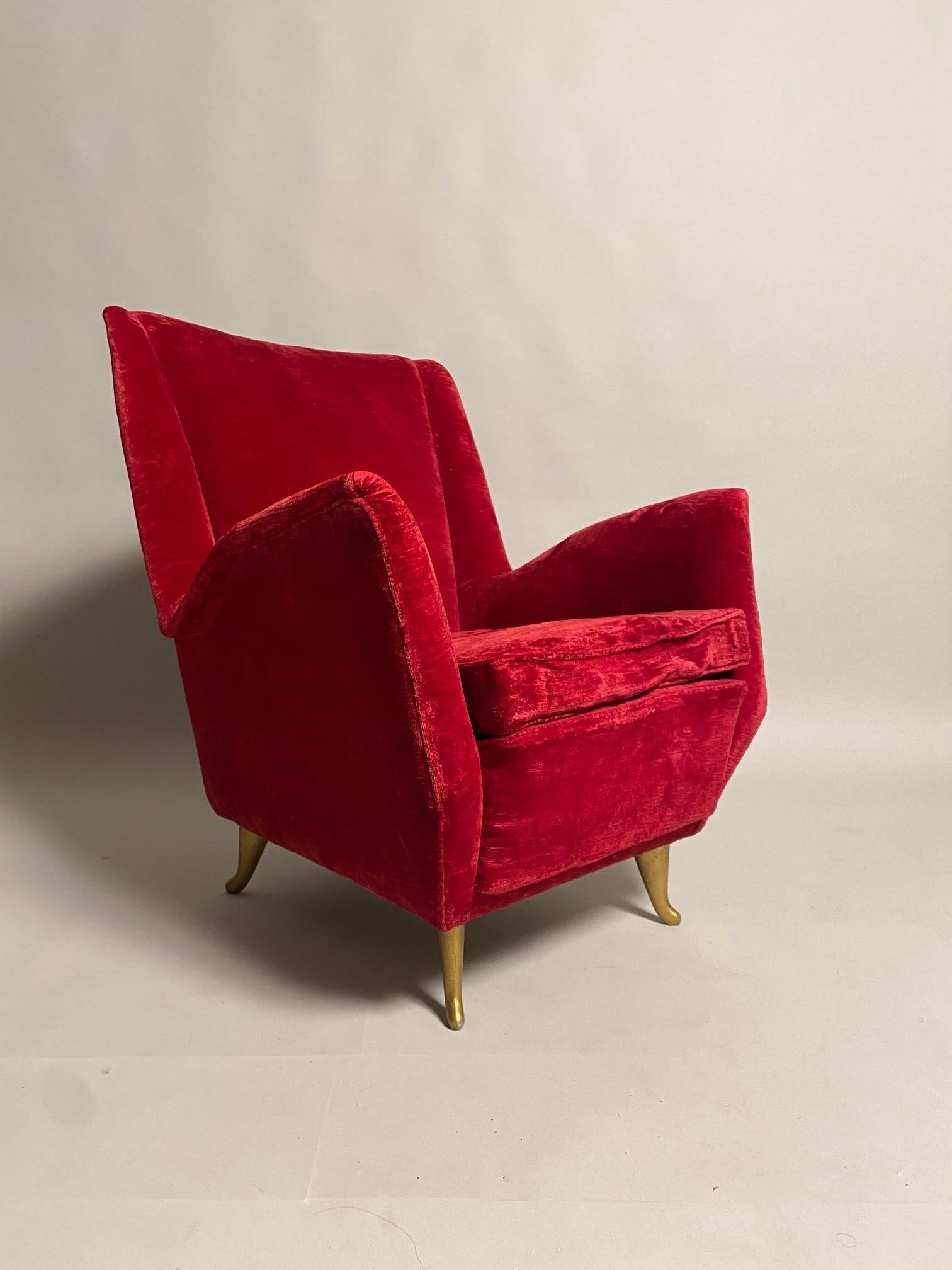 Gio Ponti (Attr.), Set of two red colored wingback chairs, design and manufacturer I. S. A. Bergamo, Italy, 1950s.  The armchairs impose themselves in the space for their elegance and refinement, and while immediately recalling the golden age of