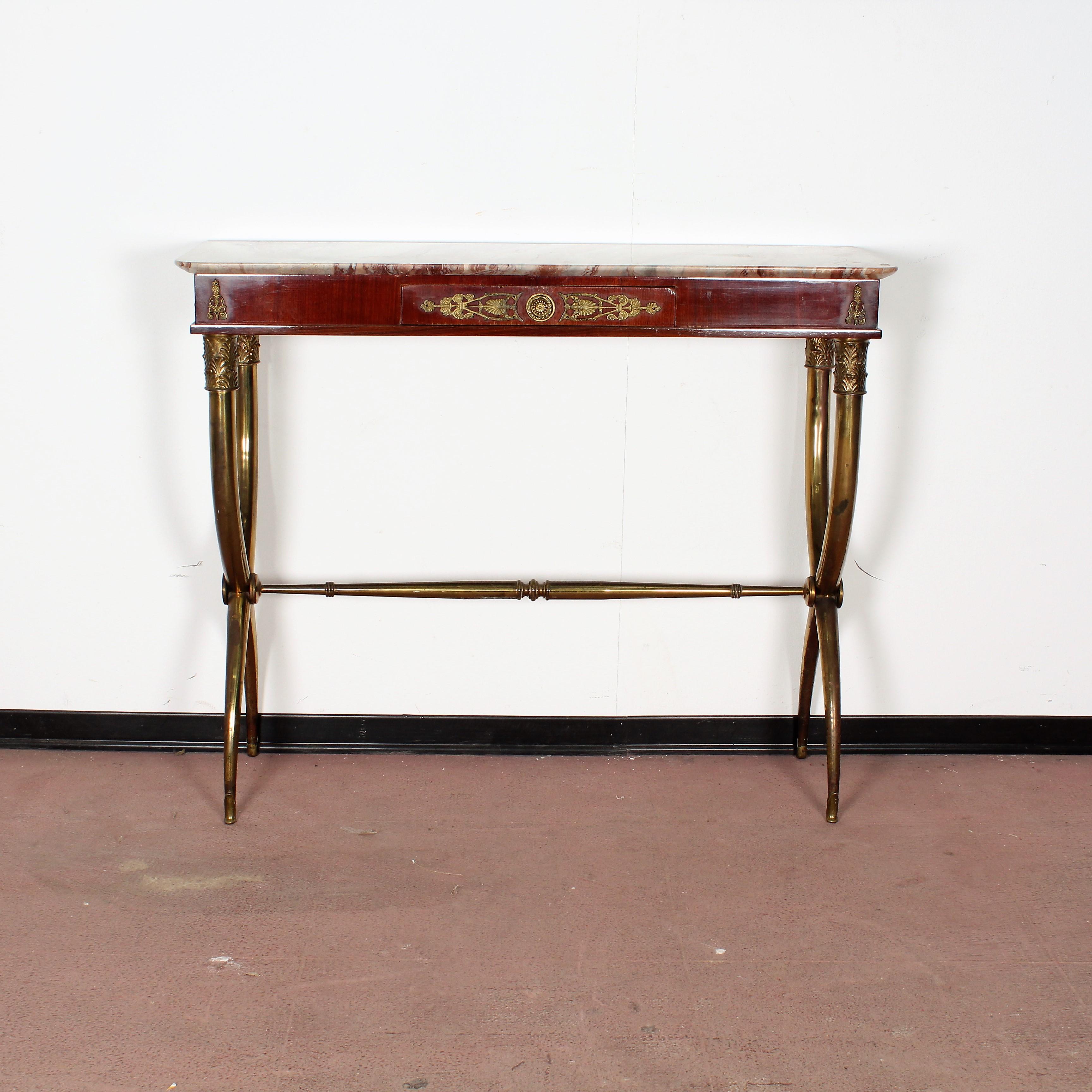 Console table in the style of Paolo Buffa made of shaped brass and wood with colored marble tops. produced in Cantu' circa 1950s.
Wear consistent with age and use.