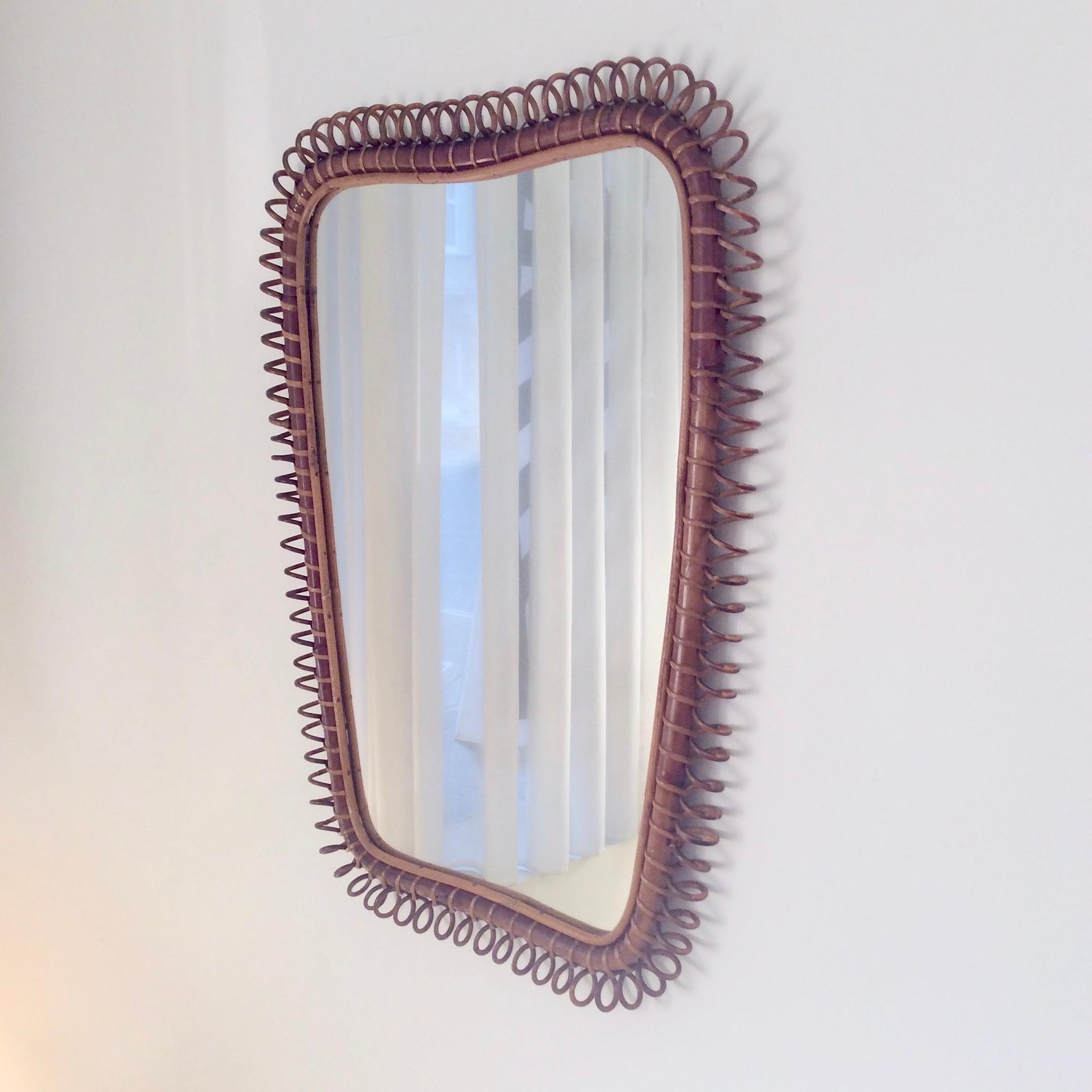 Rare and elegant large rattan and bamboo mirror, design attributed to Gio Ponti, circa 1950, Italy.
Decorative rattan spiral on bamboo frame.
Wood back.
Dimensions: 91 cm H, 71 cm W, 5 cm D.
Good original condition.
All purchases are covered by our
