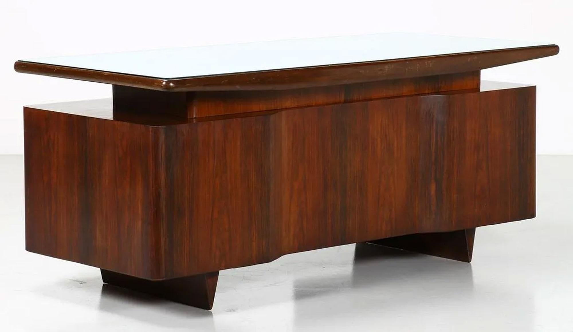 GIO PONTI ATTRIBUTED 'ROSEWOOD DESK'
c. 1950's
ROSEWOOD, CRYSTAL GLASS
31.5 H x 73 W x 33 D inches.