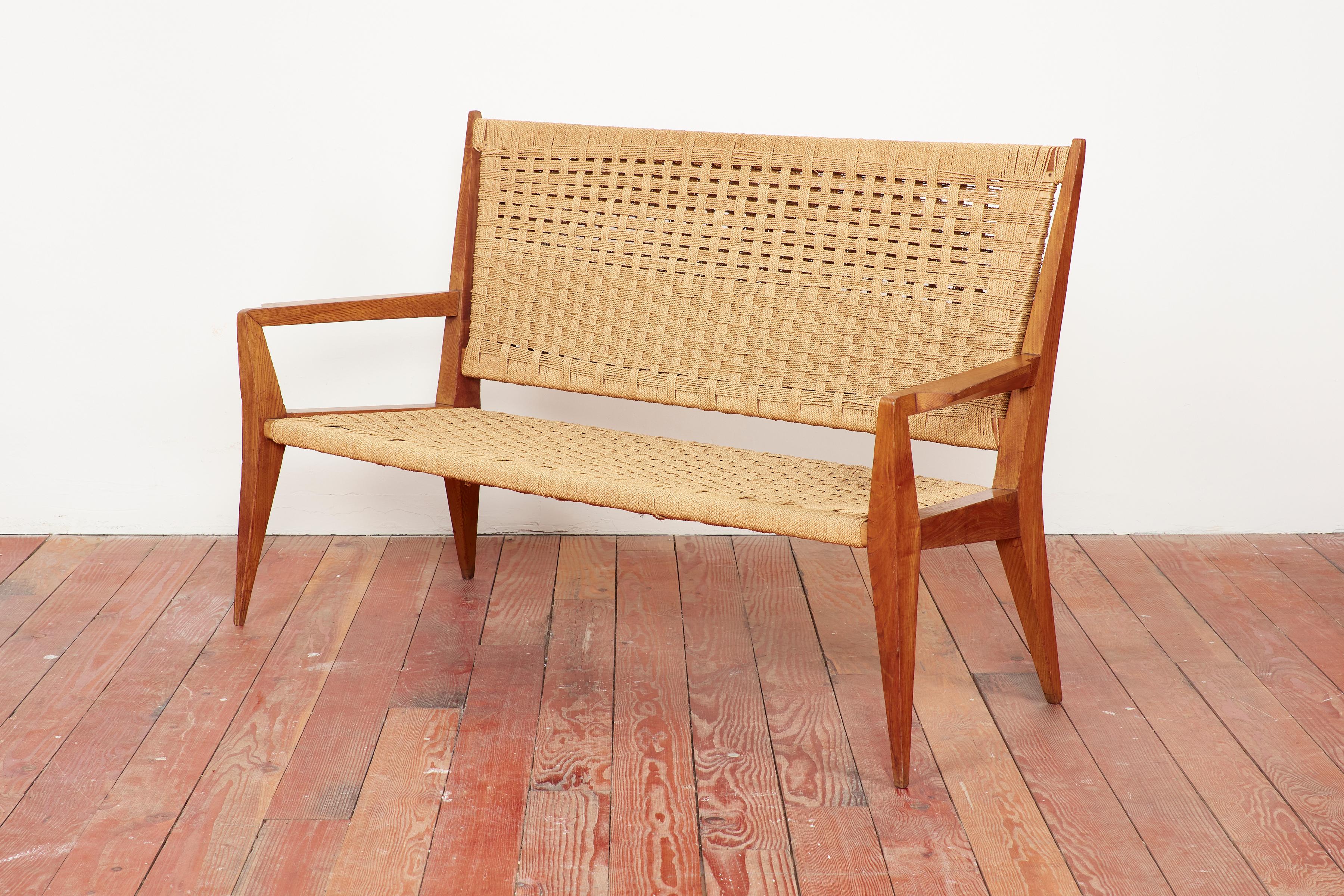 Gio Ponti attributed woven bench with perfectly angular shaped frame and woven rushed seat and back. 
Wonderful patina to wood. 
Italy, 1950s.