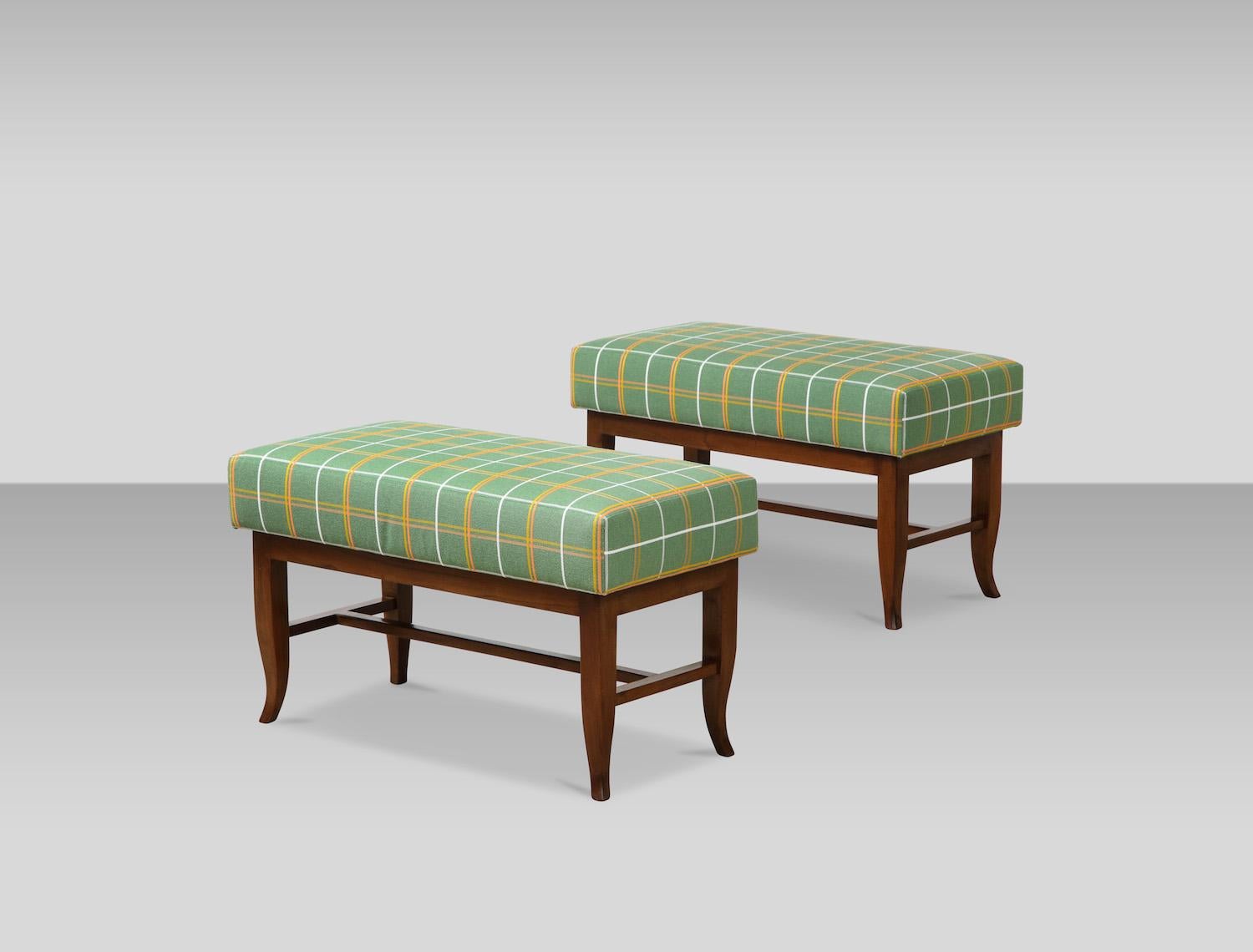 Pair of upholstered benches by Gio Ponti. Rectangular benches with walnut bases and curled lower portion of tapering legs. Very good condition. Wood has been recently cleaned and polish but was most likely refinished at some point. Cushion have