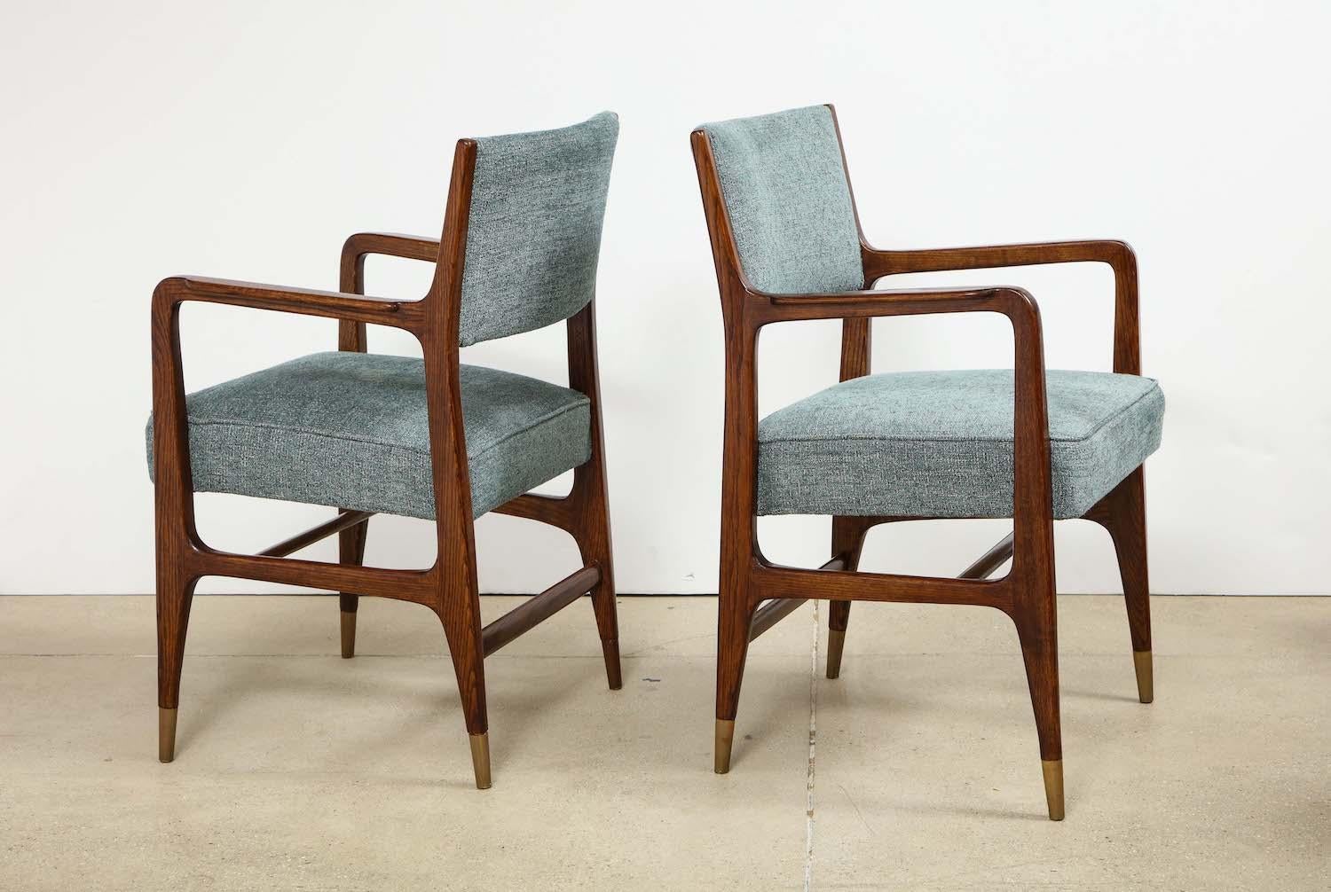 Rare pair of armchairs by Gio Ponti. Rare pair of armchairs by Gio Ponti. A rare variation of model #110, produced by Cassina. Open-grain ash chairs with upholstered seat and back and brass sabots.
  
