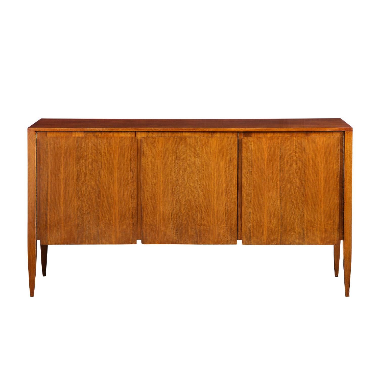3 Door credenza model 2160 in walnut with raised panels on doors and tapering legs by Gio Ponti for M.Singer & Sons, American 1950's. The interior is beautifully outfitted.

Reference:
M. Singer & Sons catalog published ca 1950