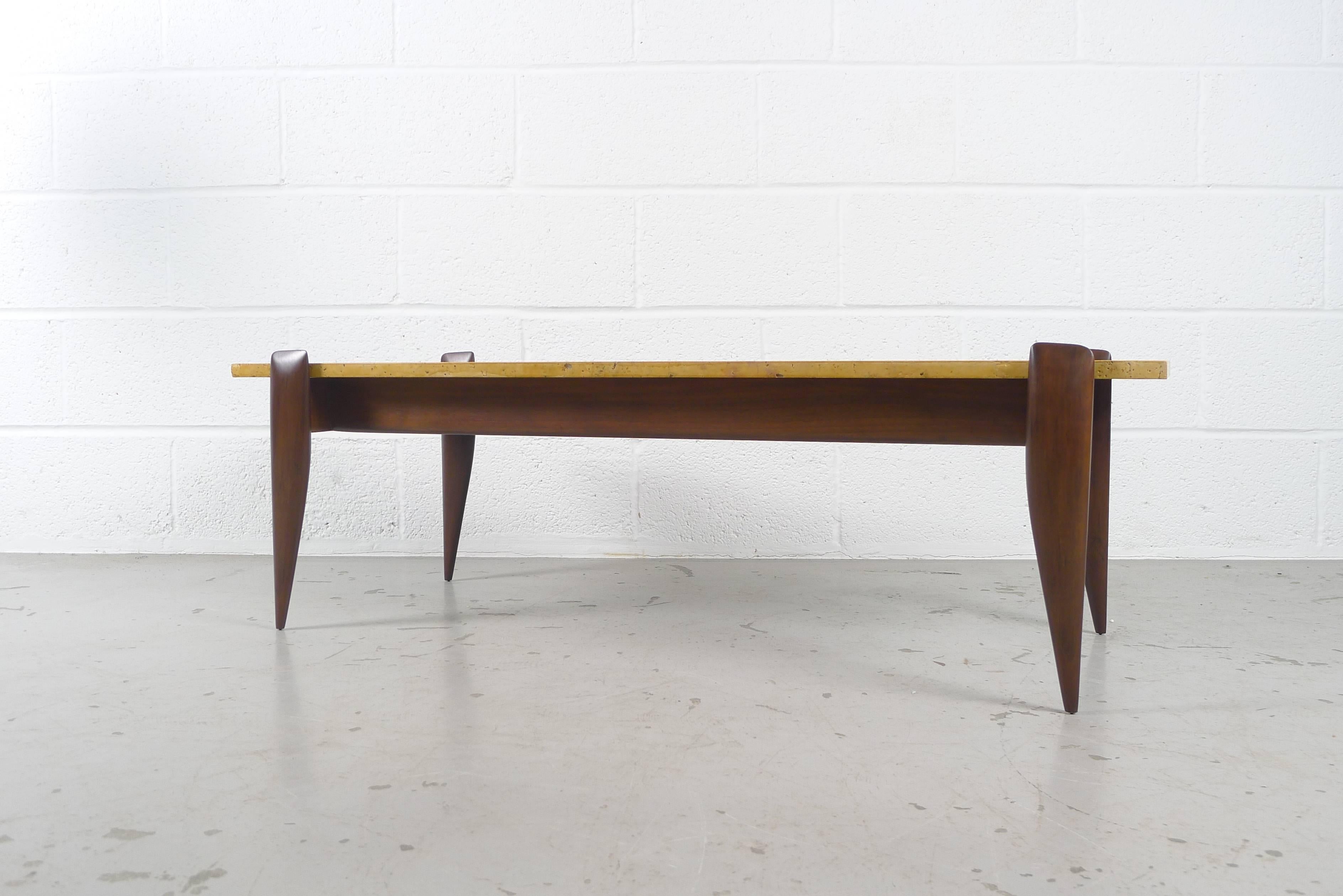 Gio Ponti for Singer and Son, USA, circa 1950s, model #2137 . Sculptural walnut base supporting a travertine plate top.

Stone has slight blemishes.