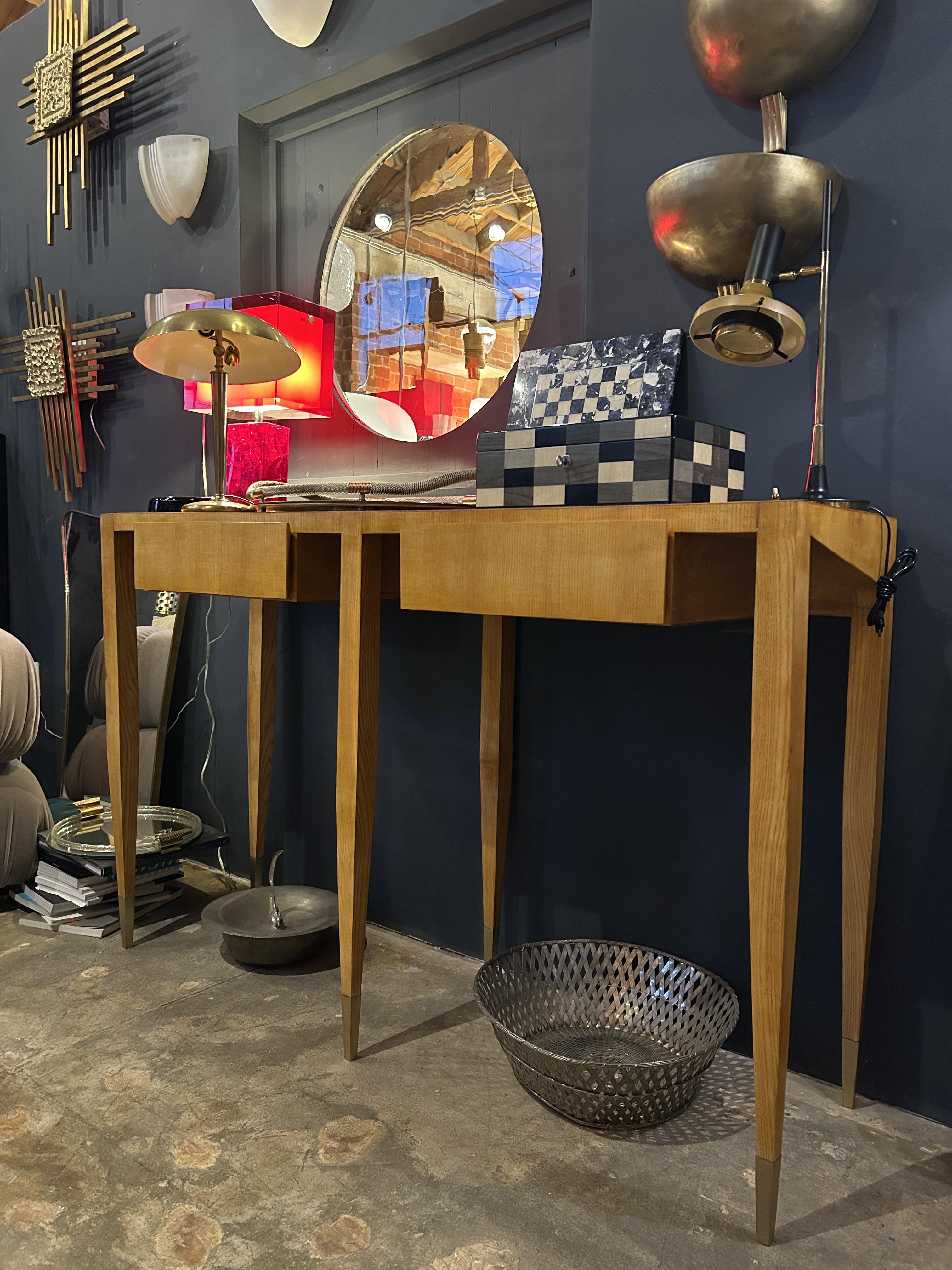 This rare and Gio Ponti console table showcases the masterful craftsmanship and refined elegance of Italian design. Featuring a sleek ash wood construction with a rich, polished finish, its tapered legs with brass metal-capped feet create a
