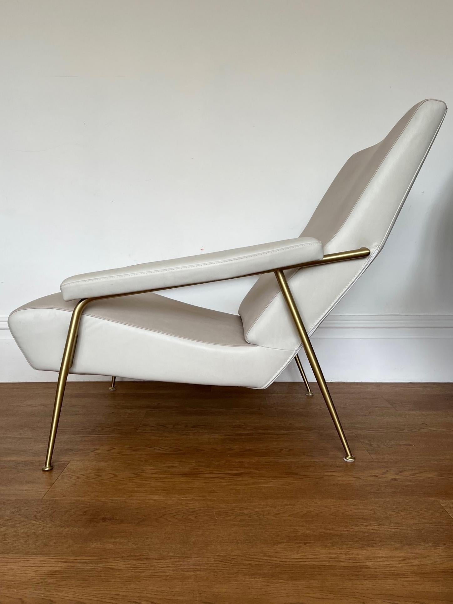 Originally designed by Italian master architect Gio Ponti in 1953 and re released in 2012 by Molteni & C.

The chair features two tone sand/paper leather with satin brass frame and legs.

The chair shows some minor signs of use with some light