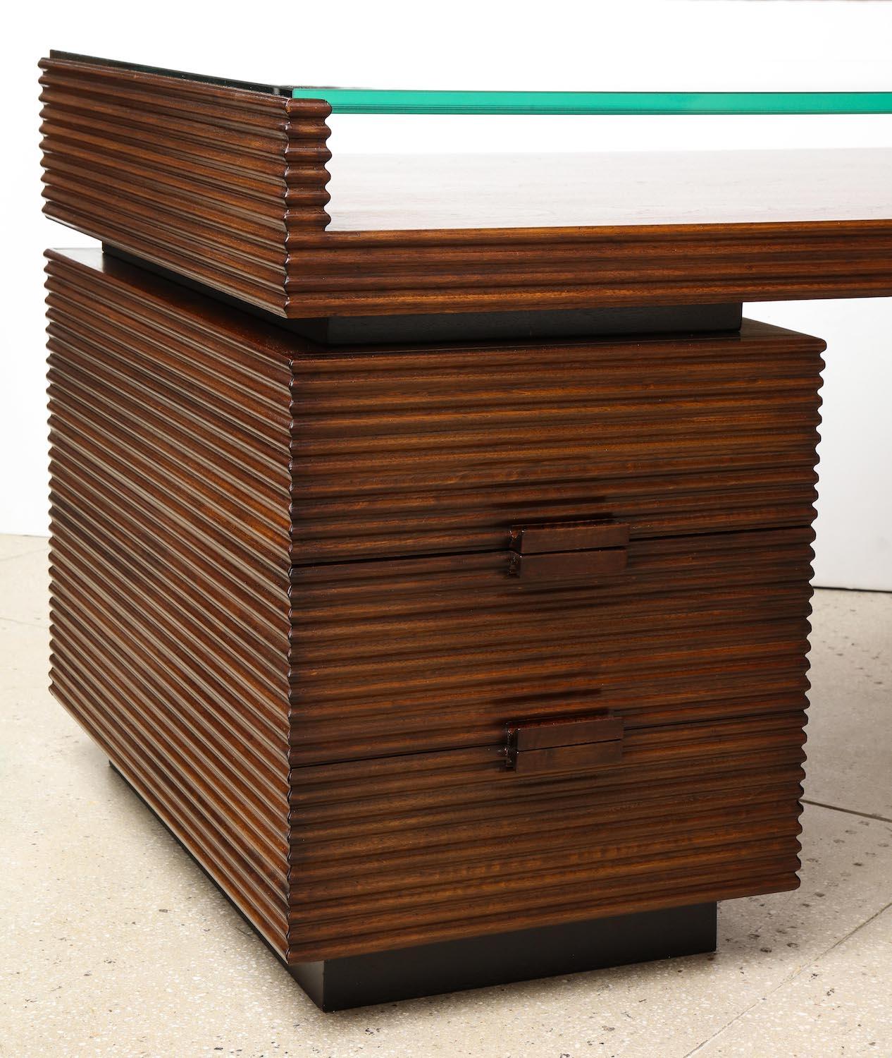 Rare partners desk by Gio Ponti. Rationalist desk from a small group created for the offices at Vetrocoke Glass Company. Incised walnut with 3 drawers on each side. Thick inset glass top. Very good restored condition. Wood has been refinished and
