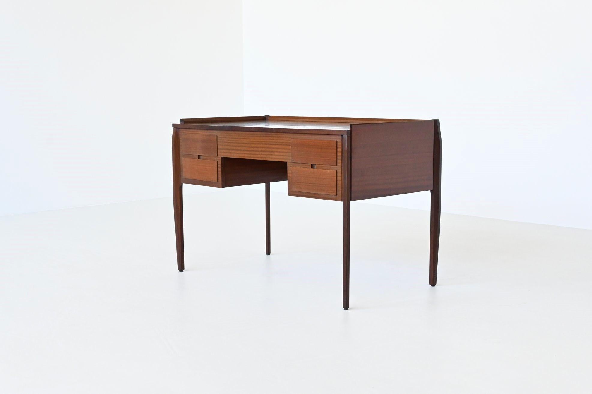 Beautiful shaped and lightweight desk designed by Gio Ponti for Vittorio Dassi, Italy 1960. This well-crafted symmetric desk is made of veneered mahogany Sapele wood and has a very nice striped grain. The desk has four deep drawers with blind