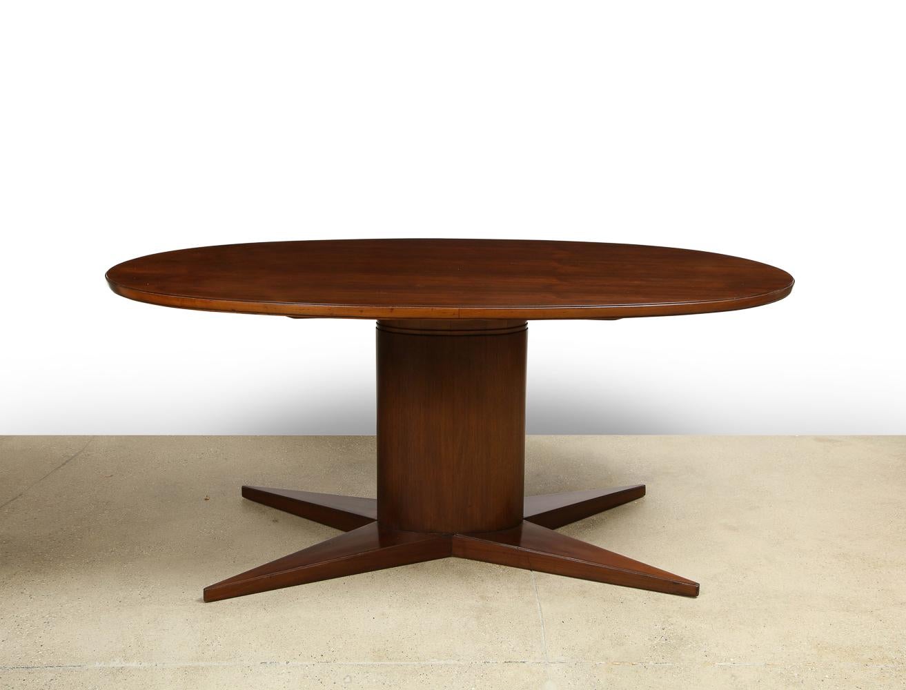 Rare & early dining table by Gio Ponti. An early Gio Ponti form in walnut, featuring an oval top, pedestal and 4-point-star shaped base. Wood has been refinished. *This table has been authenticated by the Gio Ponti Archives.