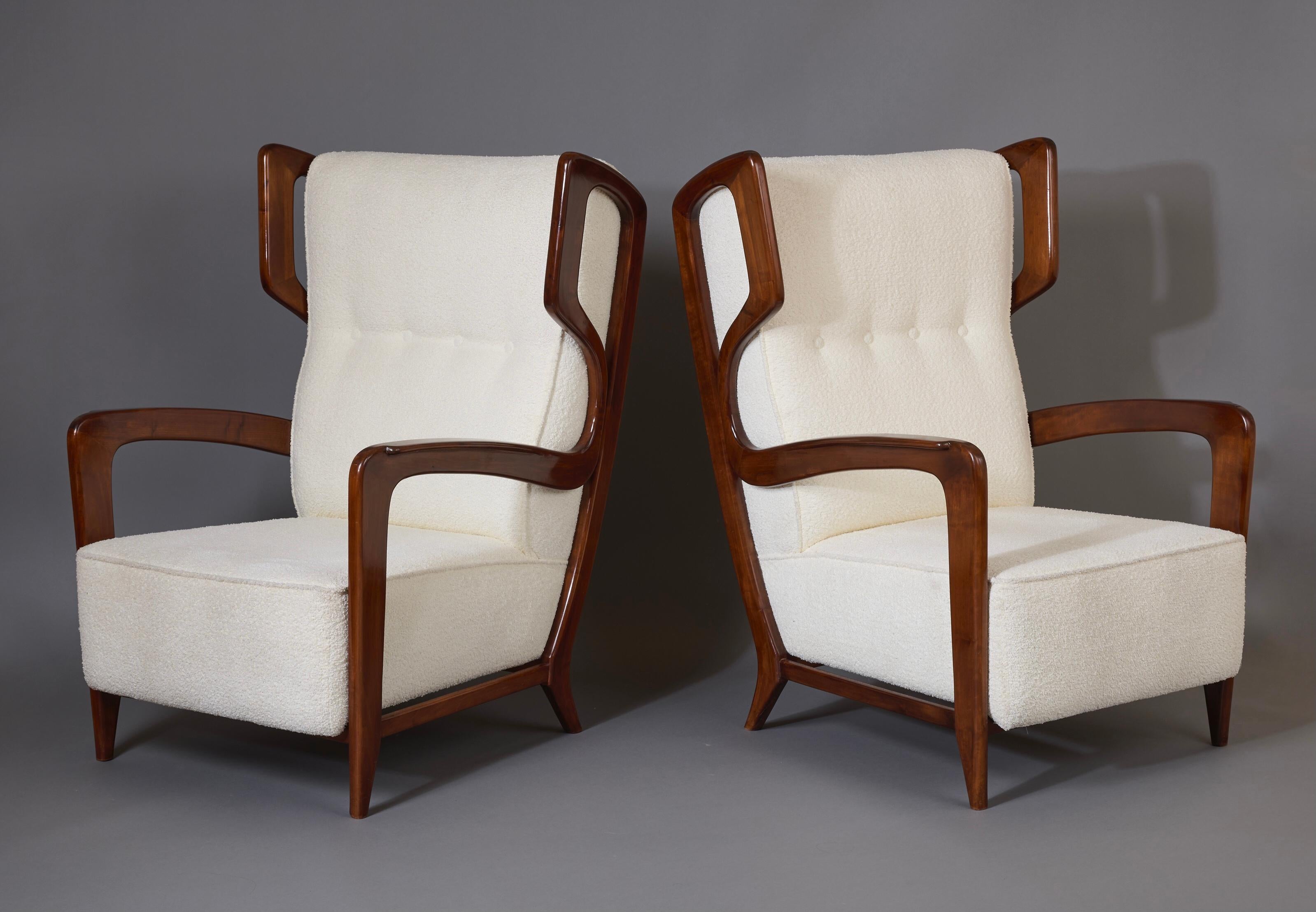 Gio Ponti (1891 - 1979)

A rare and extraordinary pair of wingback armchairs by modernist master Gio Ponti, in polished walnut with white bouclé upholstery. The chairs' striking filiform armature —a continuous ribbon that flows from the tapered legs