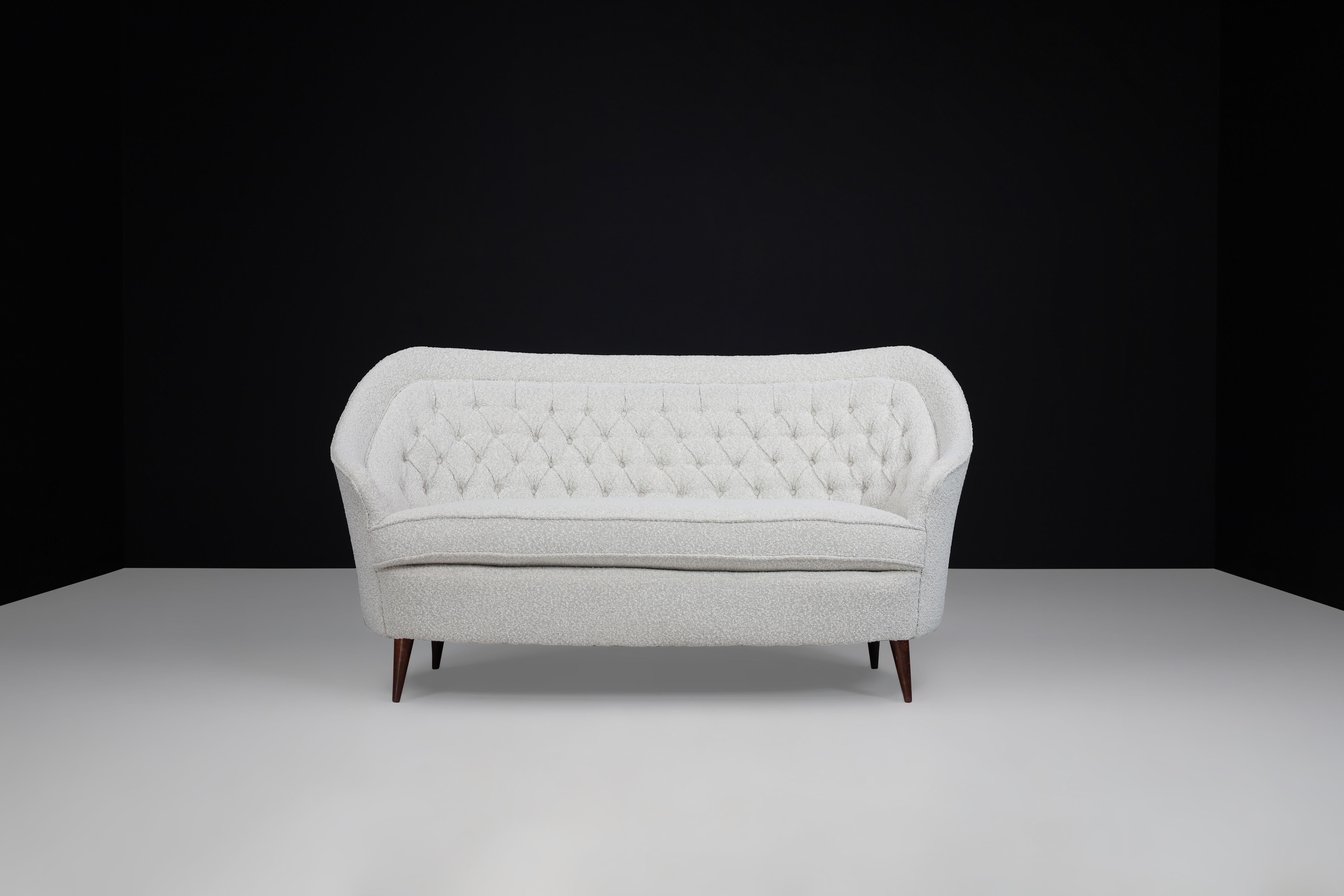 Gio Ponti For Casa E Giardino Midcentury Sofa in Bouclé upholstery Italy 1940s

This midcentury Italian sofa is undeniably elegant and comfortable. Its unique design boasts a gently sloping dome-shaped back and a scalloped front that ends on