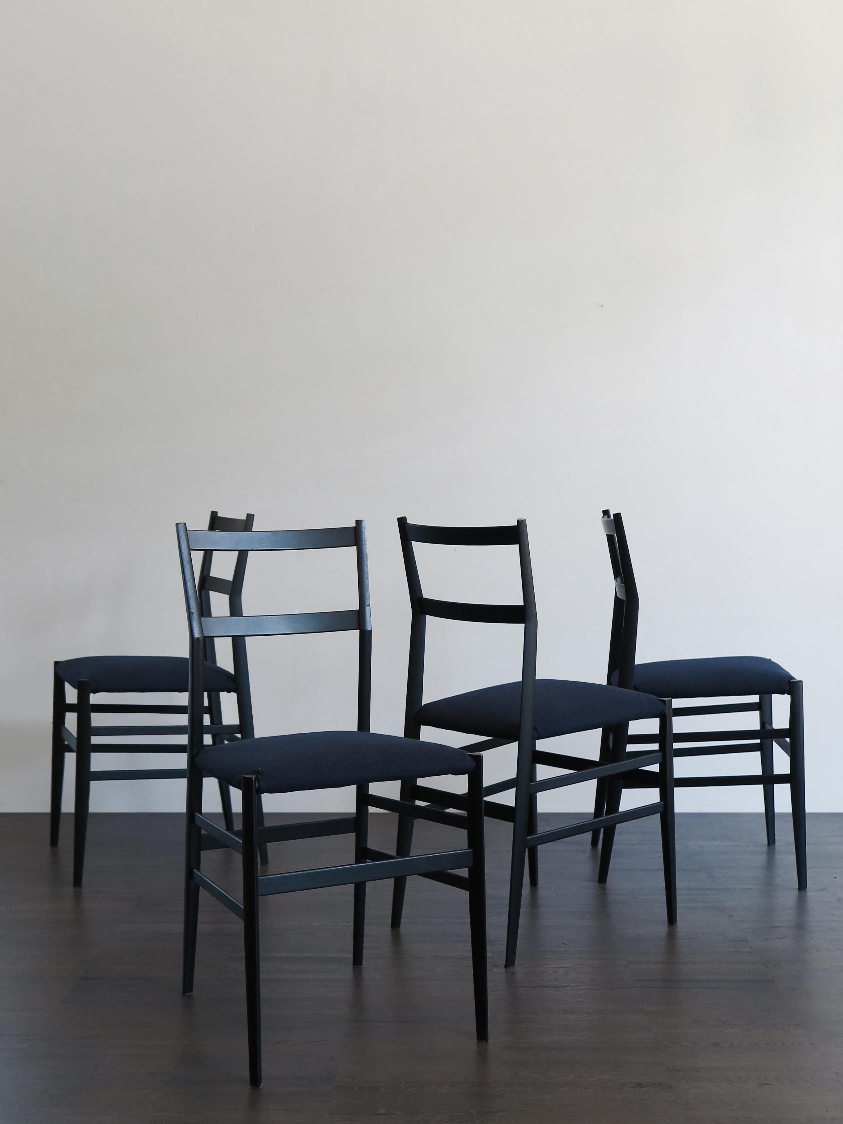 Set of four Italian Mid-Century Modern design dining chairs model Superleggera designed by Italian artist Gio Ponti and produced by Cassina, black stained ash frame and new dark blue fabric seat, manufacturer’s label, 1960s.

Bibliography:
Ugo La