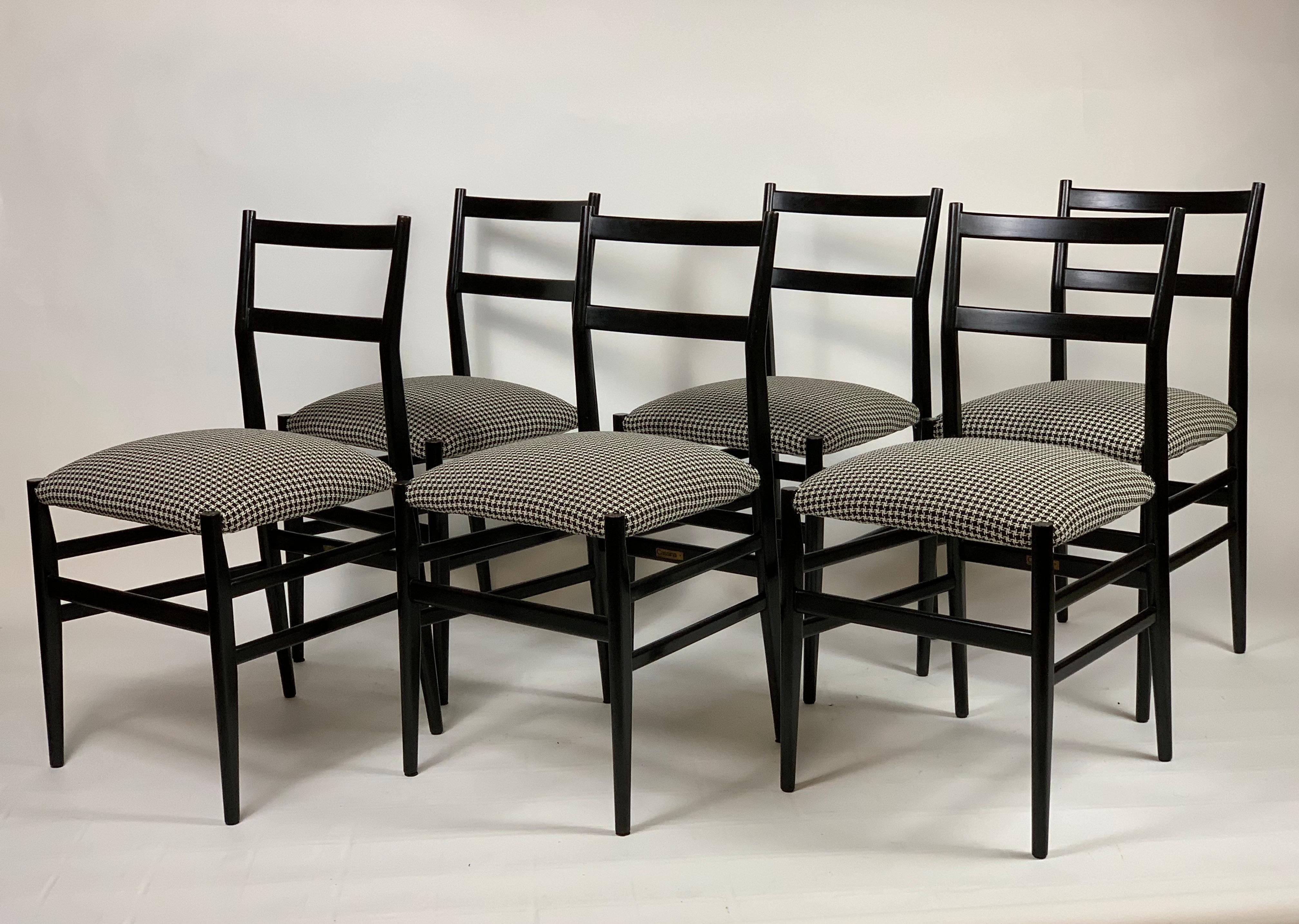 Six iconic Leggera chairs, black lacquered solid ash tree, designed by Architect Gio Ponti in the 1951, produced by Cassina, all the chairs are signed.
Newly covered with a cotton pied de poule black and white fabric.
Some little trace of use in