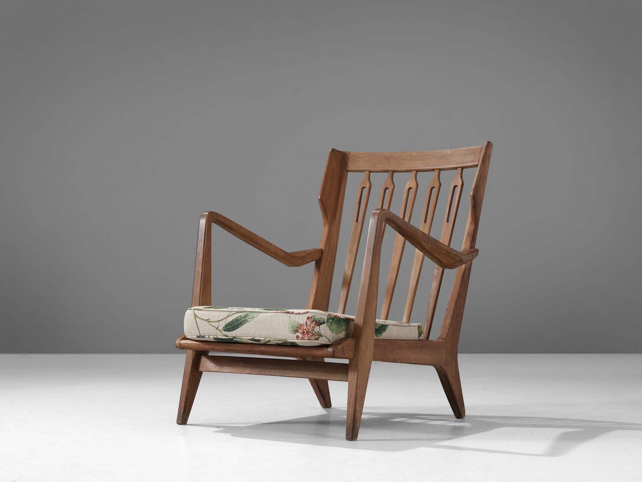 Gio Ponti for Cassina, armchair model 516, stained wood, flower print upholstery, Italy, 1955.

This chair is designed by Gio Ponti and manufactured by Cassina. The chair has a few distinct features that stand out. For instance the sculptural,