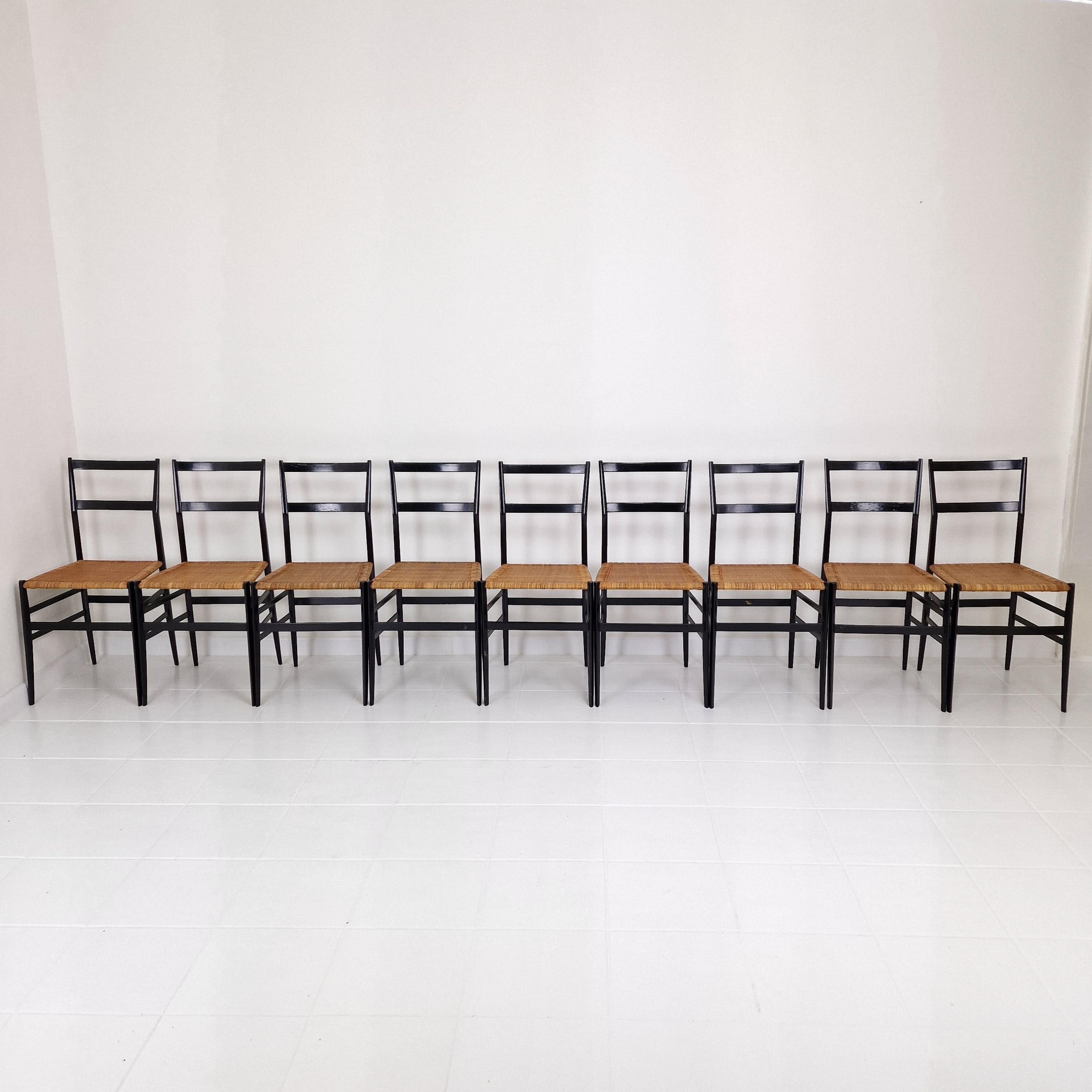 Set of 9 early edition Gio Ponti 699 Superleggera Chairs by Cassina in black, Italy, 1960's.

Gio Ponti designed the Superleggera chair in 1957 for the company Cassina. It is considered an iconic piece of furniture design and a symbol of mid-century
