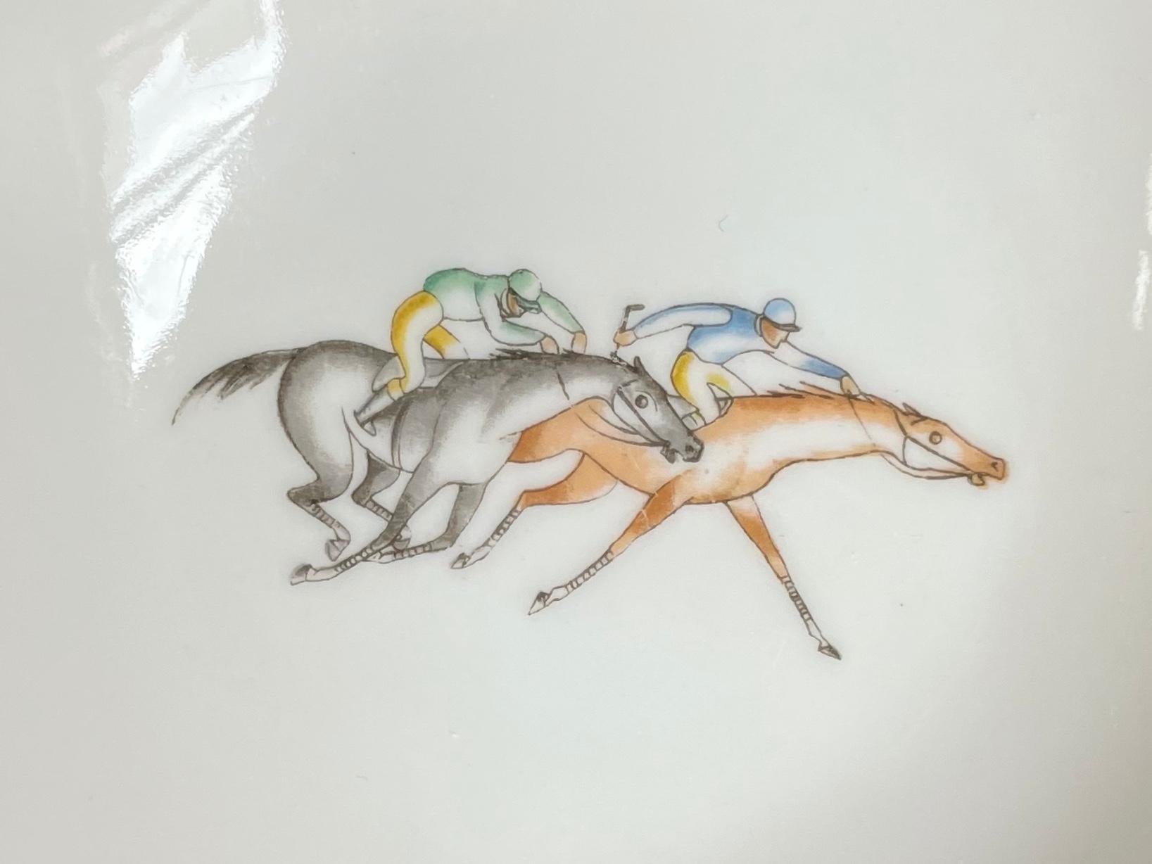 Gio Ponti for Ginori athletic dish. Vintage Richard Ginori shaped nut dish/ small saucer from the athletic series designed by Gio Ponti featuring a horse racing pair of mounted jockeys at the Derby. Italy, circa 1930's
Dimensions: 5